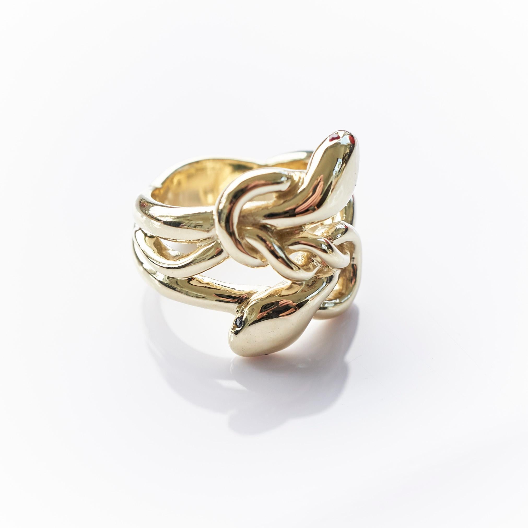 White Diamond Ruby Eyes Double Head Snake Ring Solid 14k Gold 
Designer: J Dauphin

White Diamond Eyes and  Ruby eyes on a two Snake head Ring Victorian Style
J DAUPHIN 