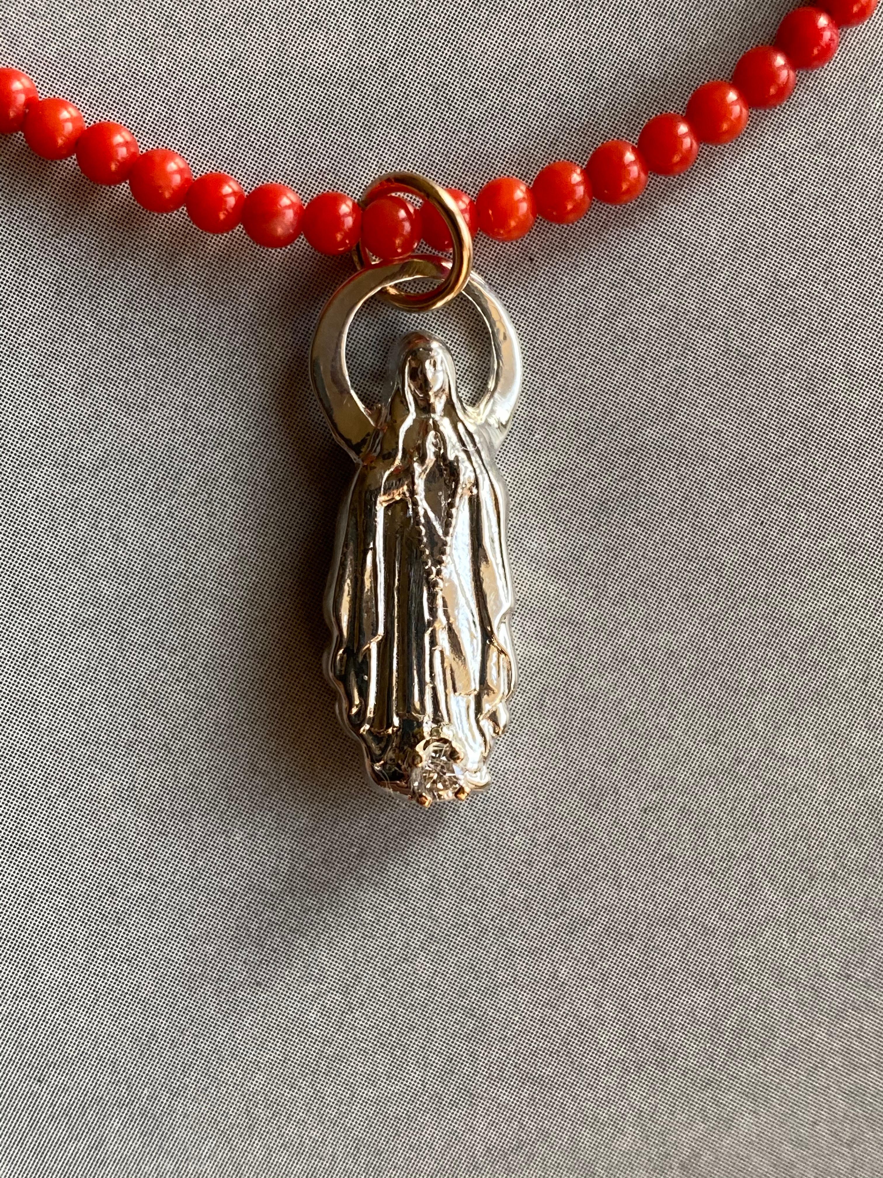 White Diamond Virgin Mary Figurine Coral Bead Choker Necklace J Dauphin

Exclusive piece with Virgin Mary pendant and an White Diamond set in a gold prong on a Silver figurine pendant. Bead Necklace is 16' long but can be made shorter or longer on
