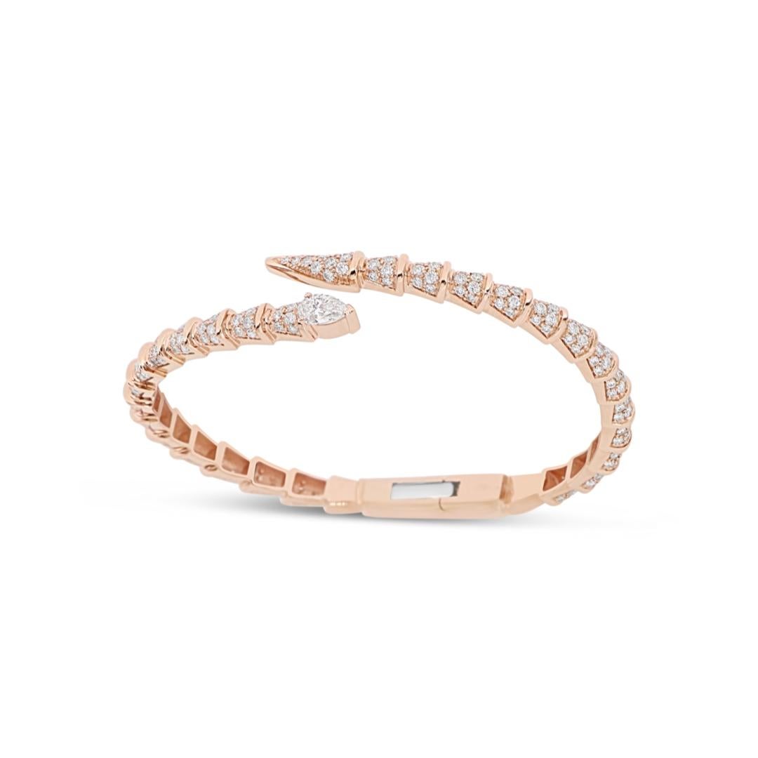 Handcrafted in Italy, this masterpiece is crafted in 18kt rose gold and features a captivating white diamond (pear brilliant cut) as the head of the stylized snake, while the rest of the bracelet is set white round-cut white diamonds (2.49ct). This