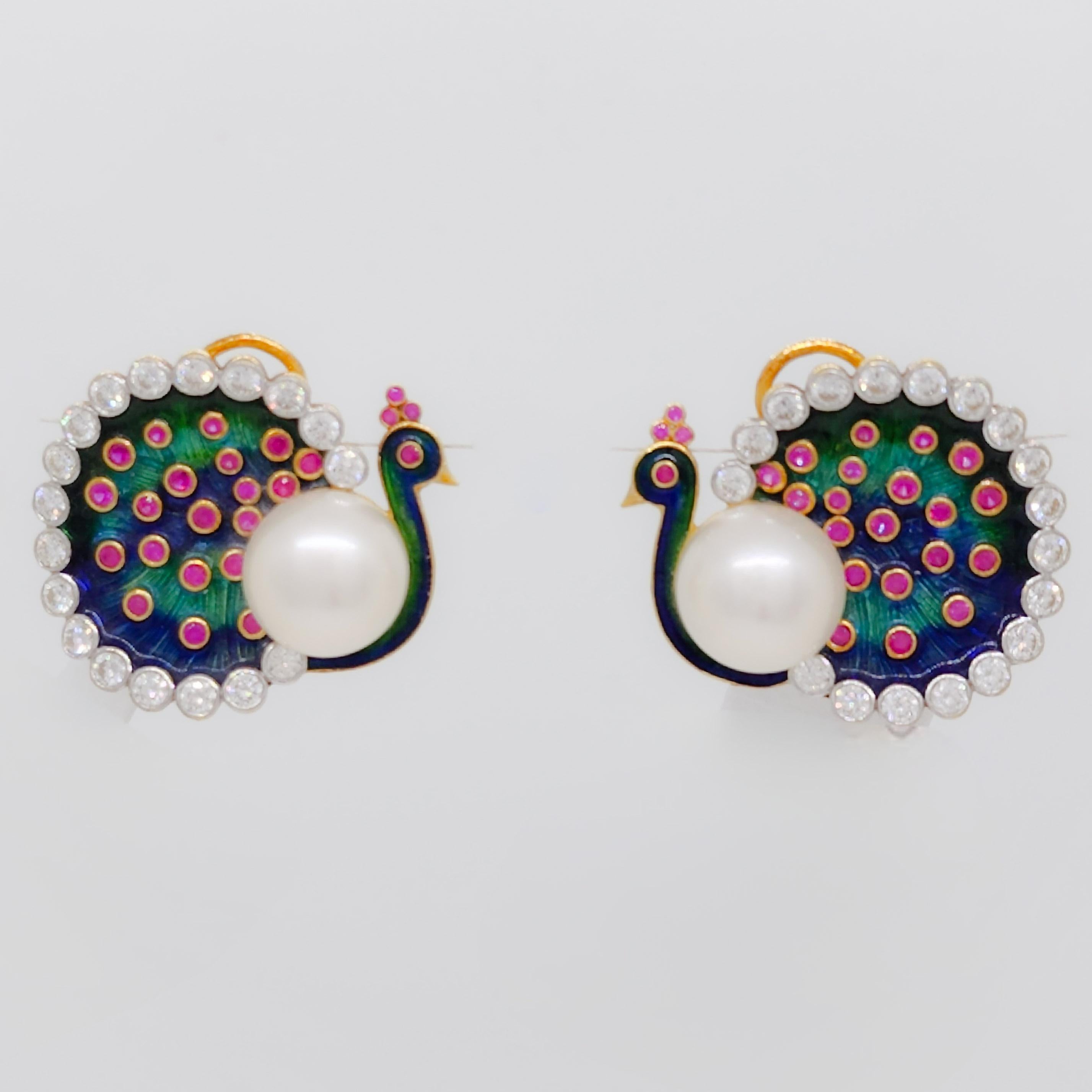 Absolutely stunning peacock design earrings with white diamond rounds, South Sea pearls, and enamel work.  Handmade with detail in 18k yellow gold.