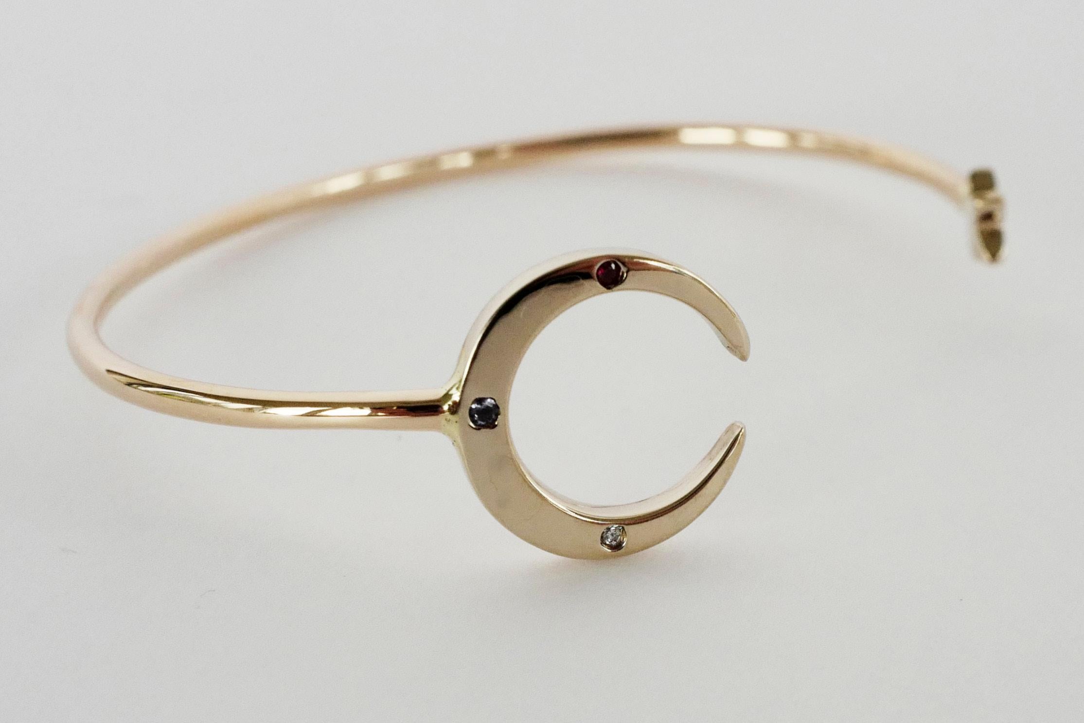 Crescent Moon Star Bangle Bracelet White Diamond Tanzanite Ruby J Dauphin

Hand made in Los Angeles

The word “crescent” comes from the Latin term ceres meaning to “bring forth, create” and crescere, the Latin term for “grow, thrive”.
It is used as