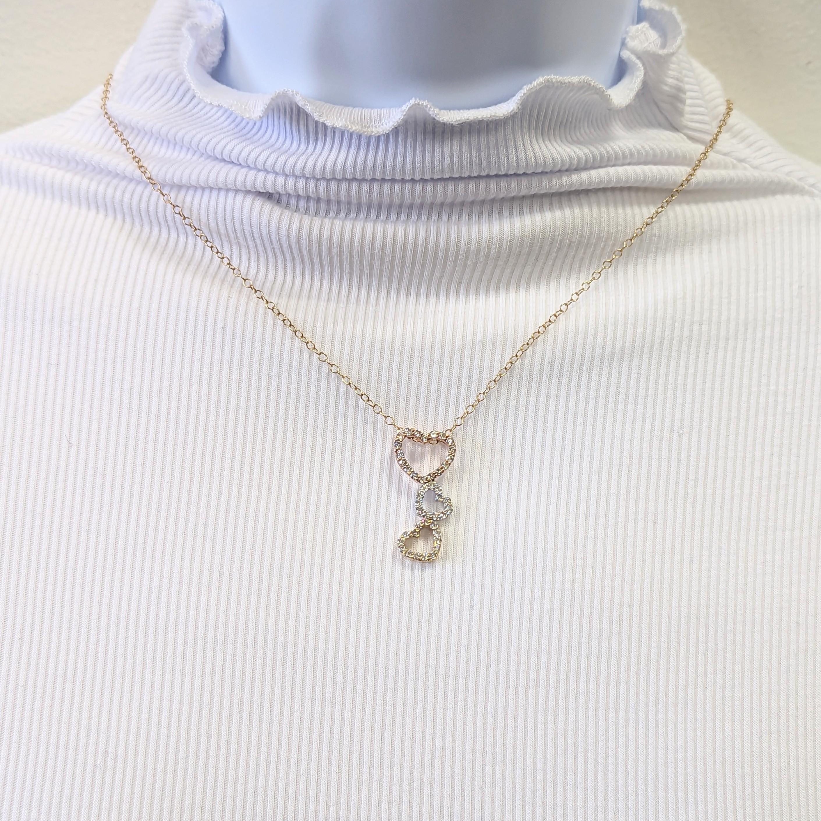 Beautiful triple heart pendant with 0.92 ct. good quality, white, and bright diamond rounds.  Handmade in white, yellow, and rose 14k gold.  Length of necklace is 16