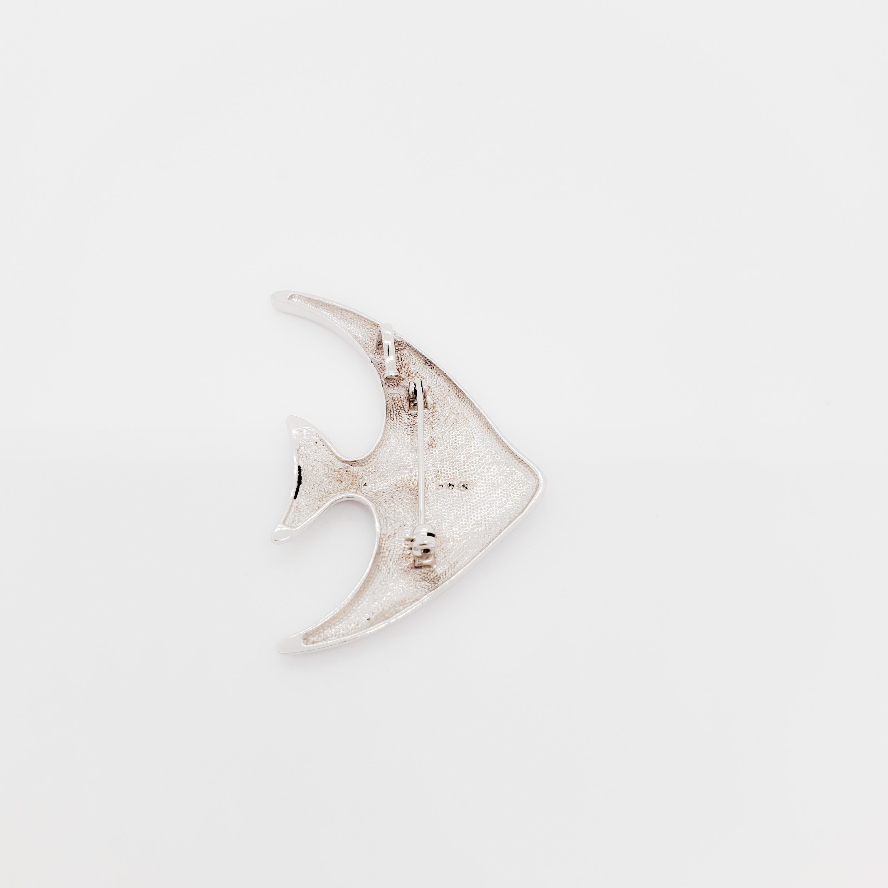 Very unique tropical fish pendant/brooch handmade in 14k white gold.  This piece has 1.00 ct. of good quality, white, and bright diamond rounds.