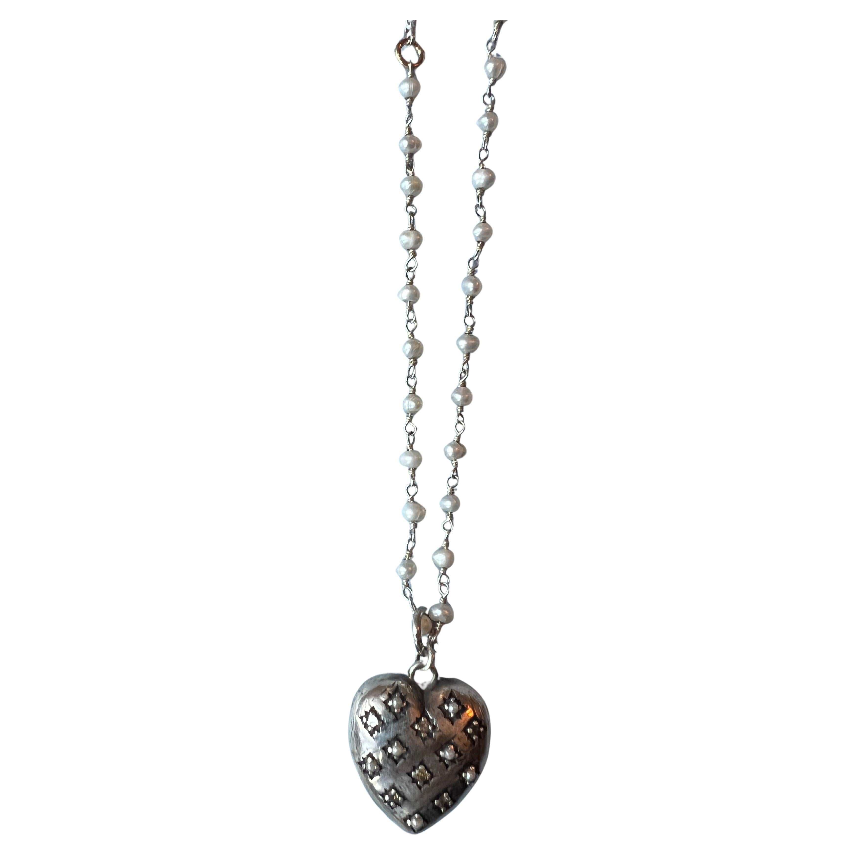 Silver Haert White Diamond White Pearl Rosario Necklace 

White Diamond White Pearl Puffy Heart in a Victorian Style hangs on a Silver Rosario white pearl Necklace Chain 

Designer: J DAUPHIN

Length: 24 inches - Can be made shorter on