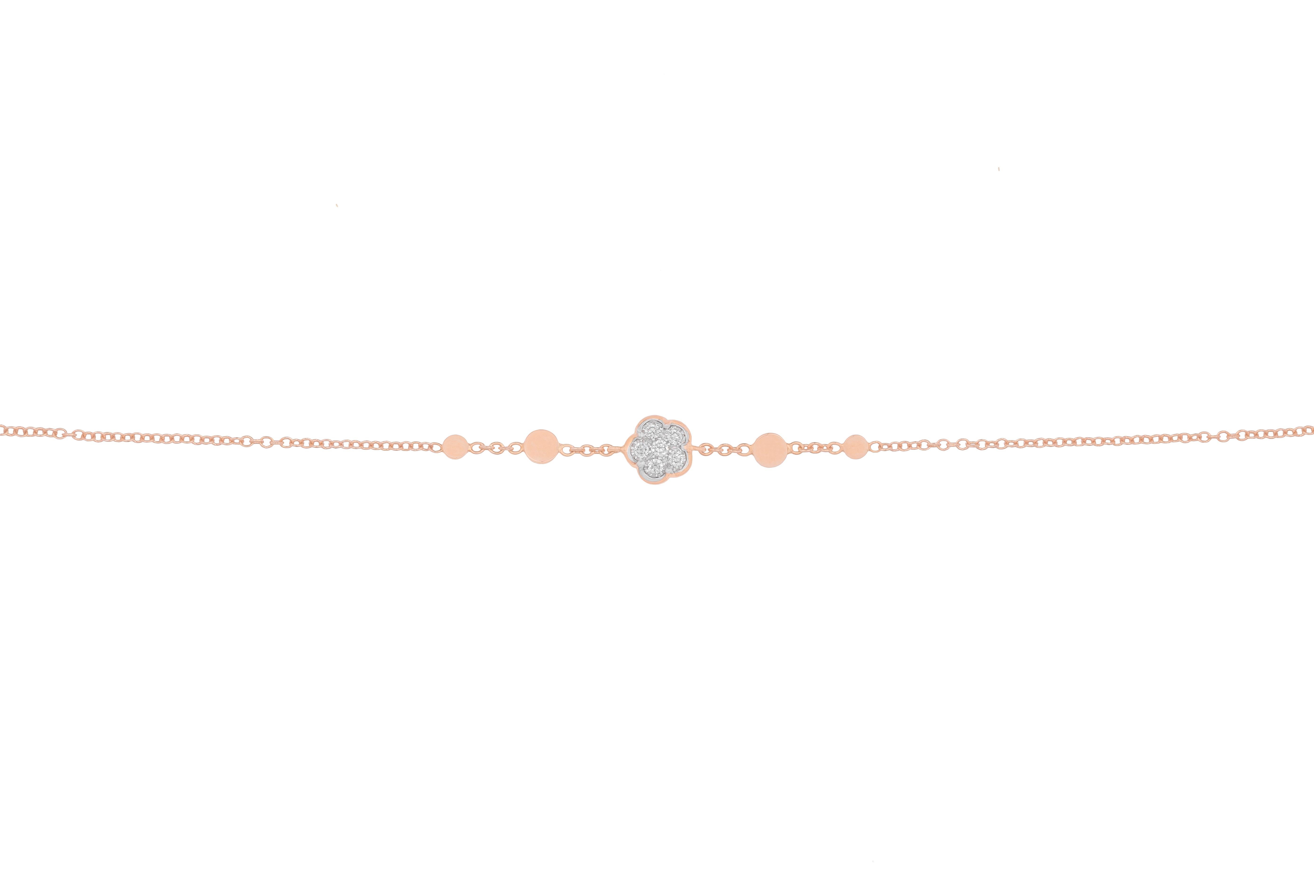 This 18K rose gold and white diamonds bracelet is made in Italy by Pasquale Bruni.
It features a small flower in the centre with 6 brilliant cut white diamonds. On both sides of the flower we find four rose gold flat balls.
Two heart shaped rings at