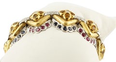 White Diamonds, Blue Sapphires, Rubies White and Yellow Gold Link Bracelet