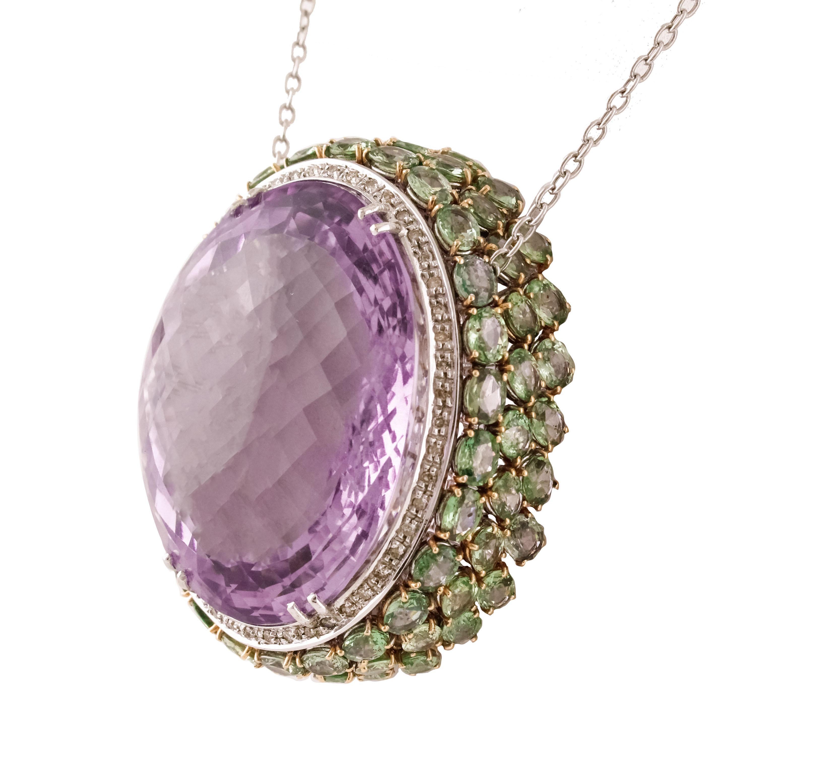 Amazing pendant necklace composed by big intense-color amethyst in the center (37.30 g) surrounded by white diamonds crown and green sapphires all around; all mounted on 14K white gold structure. It's support by 14k white gold chain
Diamonds 0.58 ct