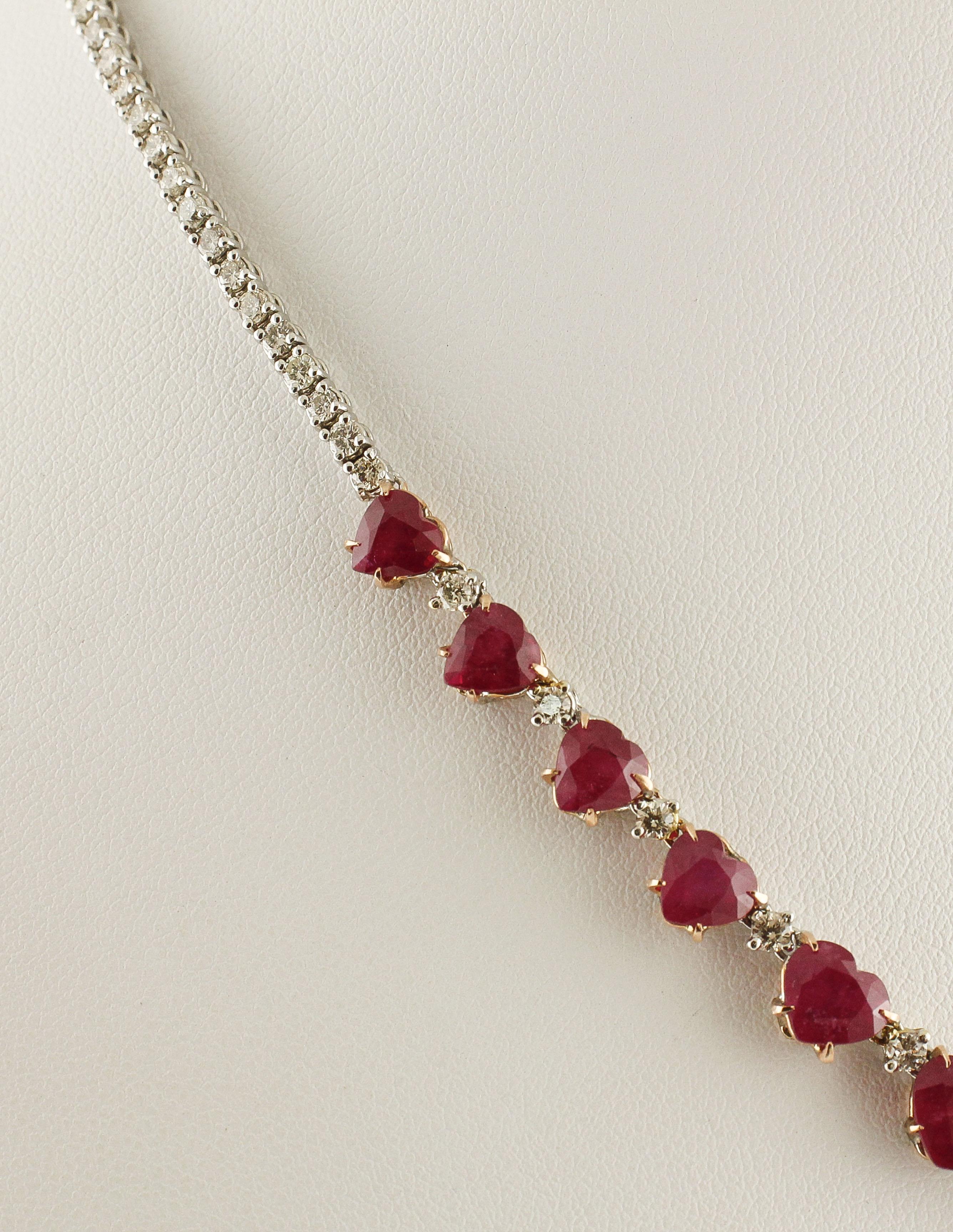 Simple and elegant tennis necklace in 14K white and rose gold with white diamonds on the back and a sequence of heart-shaped rubies of intense color among which there are little white diamonds
Diamonds 3.55 ct 
Rubies 24.26 ct 
Total Weight 23.20 g