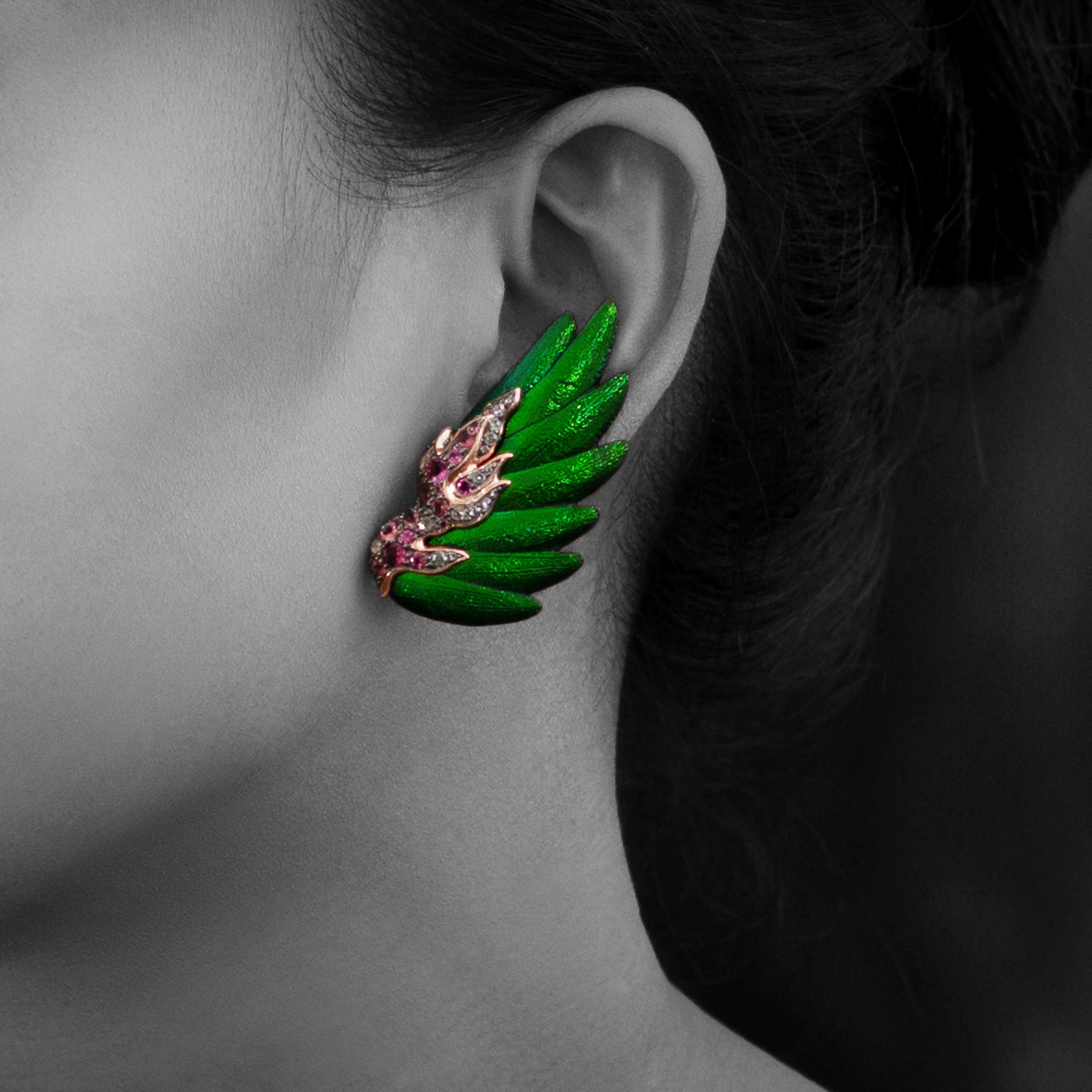 A pair of scarab earrings in a fancy angel wing design is embellished with pink tourmalines and rose-cut white diamonds mounted in black rhodium sterling silver and 9K pink gold.  
wt. 24.76g
Dimension: 4.7x2.5x0.9 cms. 

Pink tourmalines: 2.50