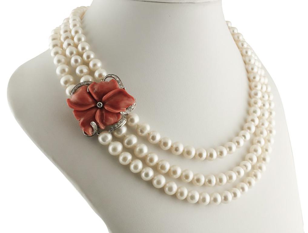 Amazing and refine beaded pearls necklace composed of the white pearls rows and mounted with 18K white gold clasp decorate with red coral flower one diamond in the center and surrounded by white diamonds.
Diamonds 0.86 ct 
Red Coral Flower 12.60 g