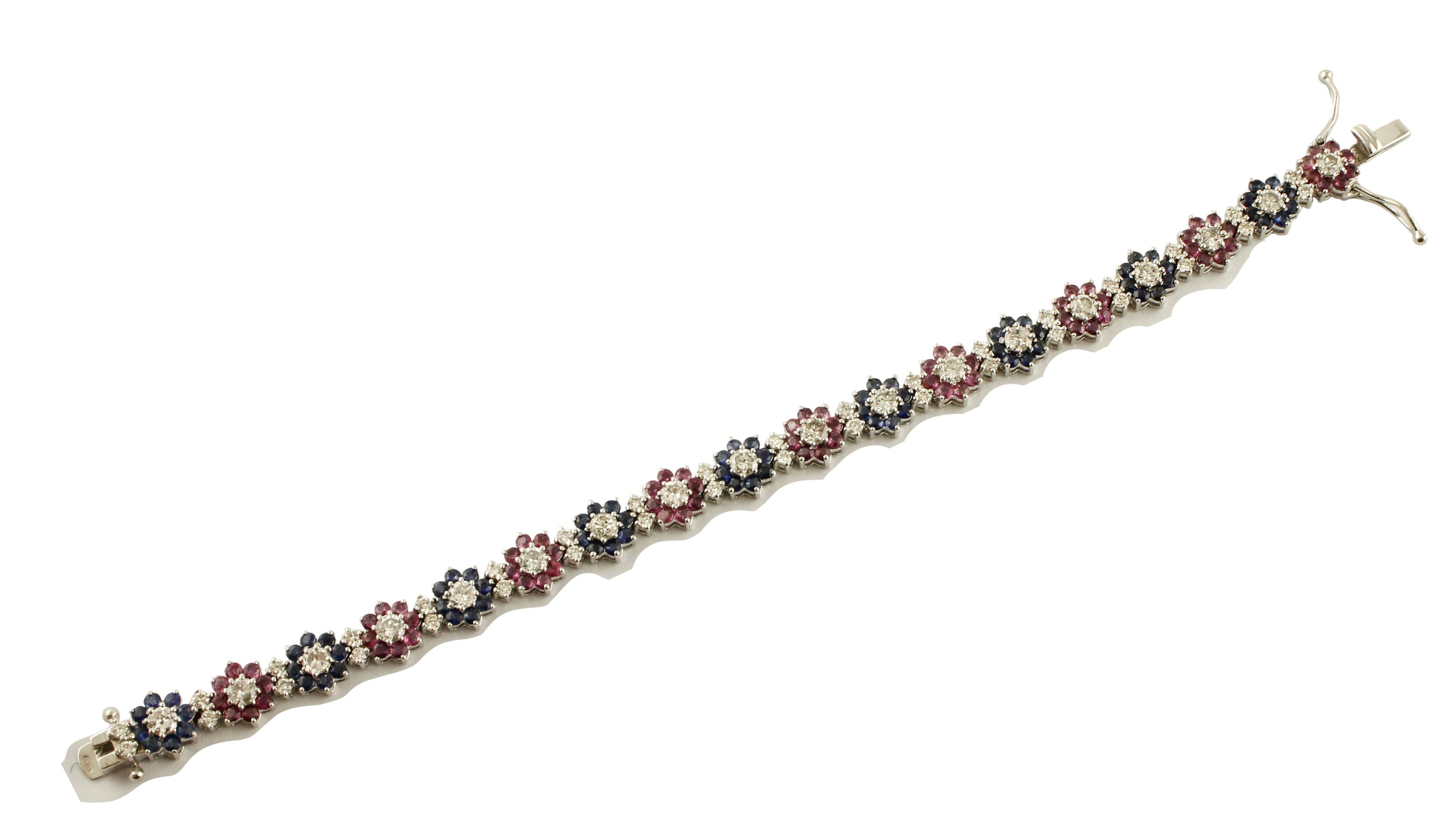 Refine link/tennis bracelet, (flower theme) in 18K white gold composed of white diamonds and blue sapphires flowers and white diamonds rubies flowers.
Diamonds 3.62 ct
Rubies and Blue Sapphires 6.83 ct 
Total Weight 19.50 g 
R.F + rgfr
Length 17.5