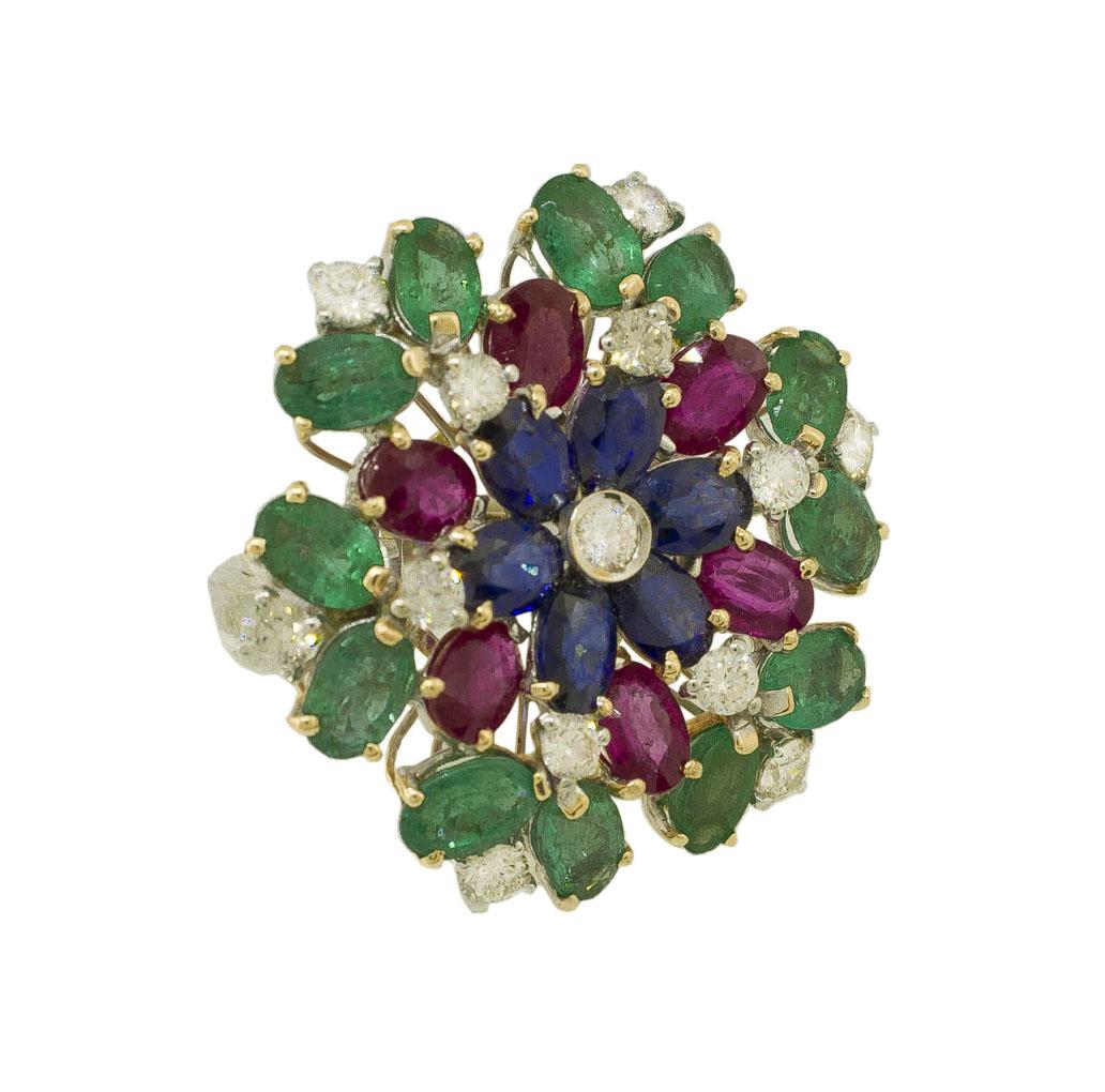 Amazing flower shape fashion ring in 14K white and rose gold composed by little blue sapphires and white diamond flower in the center, other rubies and emeralds petals and it is adorned by shining white diamonds.
Diamonds 1.55 ct 
Rubies, Emeralds,