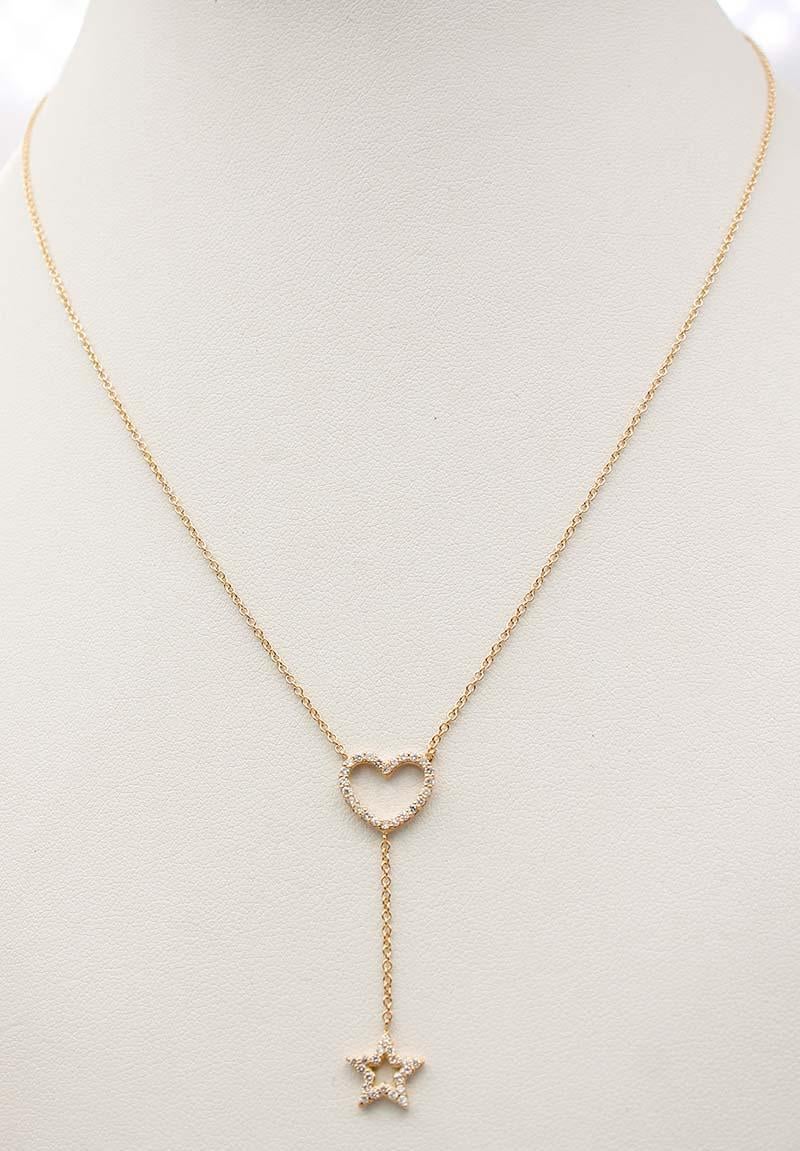Gorgeous necklace in 18 karat yellow gold mounted with two structures  heart shape and  star shape  studded with white diamonds.
Diamonds 0.38 ct
Total Weight 3.50
RF  +GERE
Lenght Pendant 4.2 cm
Lenght Chain   45 cm

For any inquiries,please