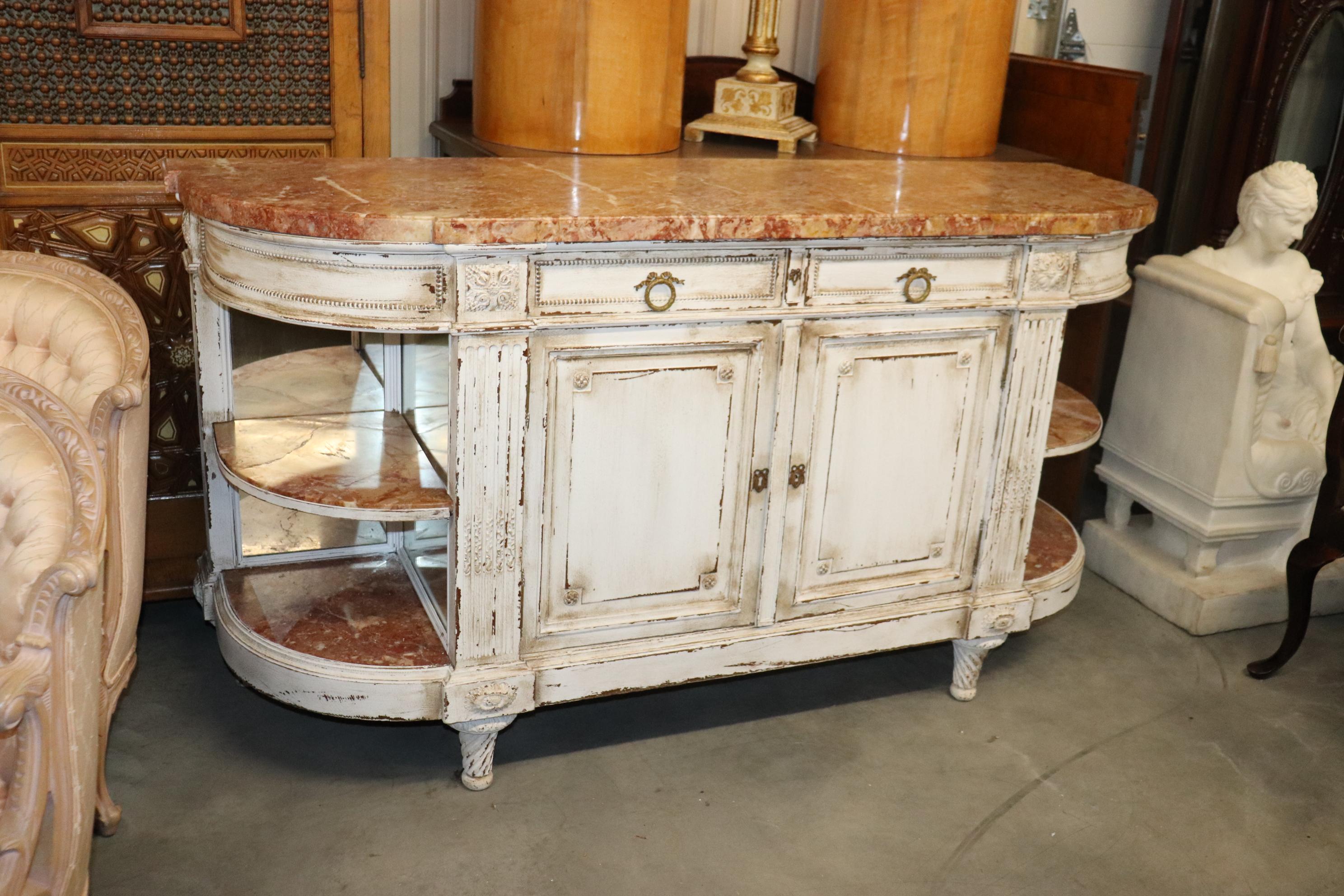 This is a superb antique distressed painted sideboard. The lines, the marble and the color really make a statement and pop! This is impossible to ignore! The marble top is in good condition as is the rest of the case. Notice the shelves are marble