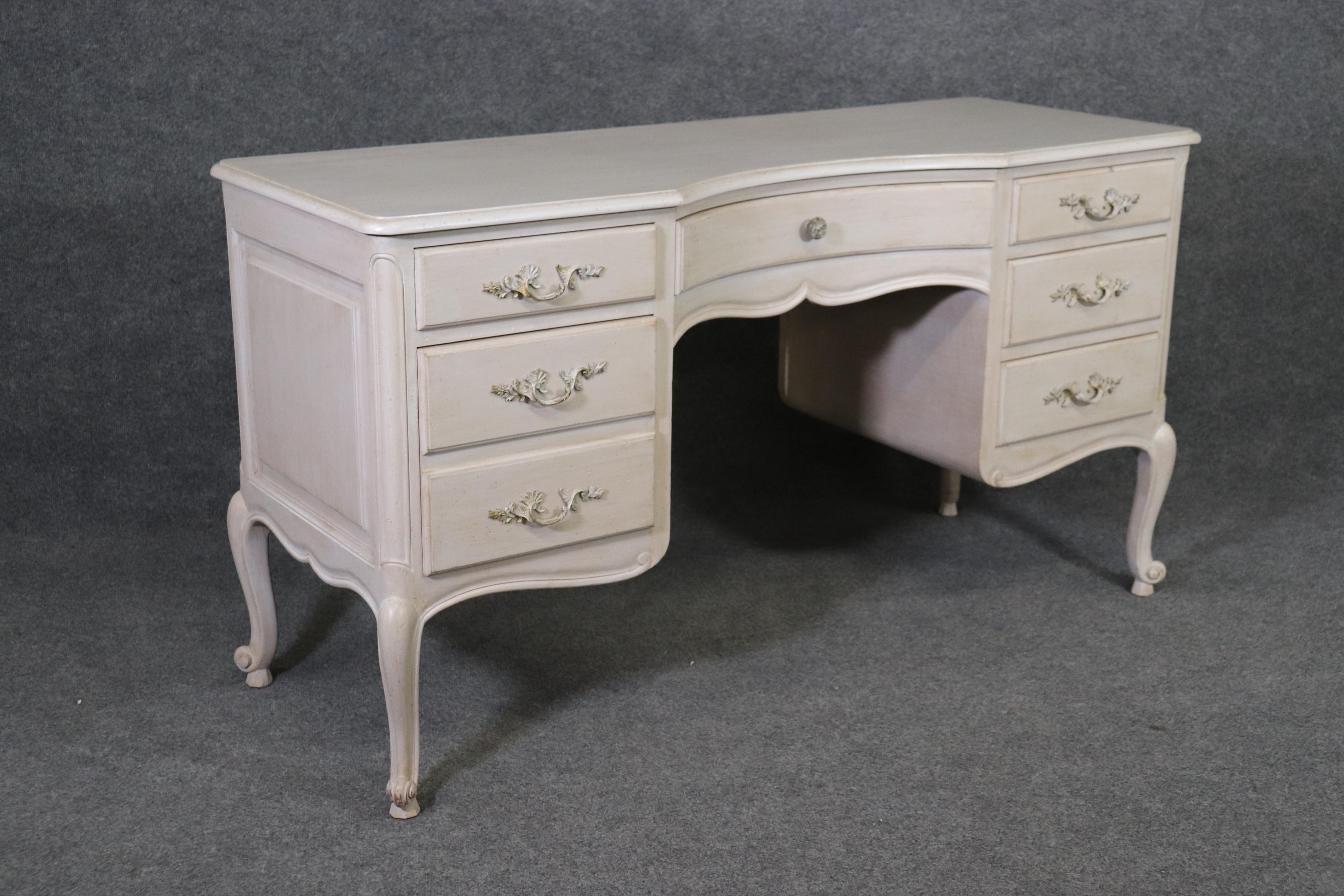 This is a beautifully done shallow depth French Louis XV style American made ladies vanity or writing desk. The piece can be used as a desk because the back is finished. The piece is in good condition and measures 55.5 wide x 21 deep x 30.25 and