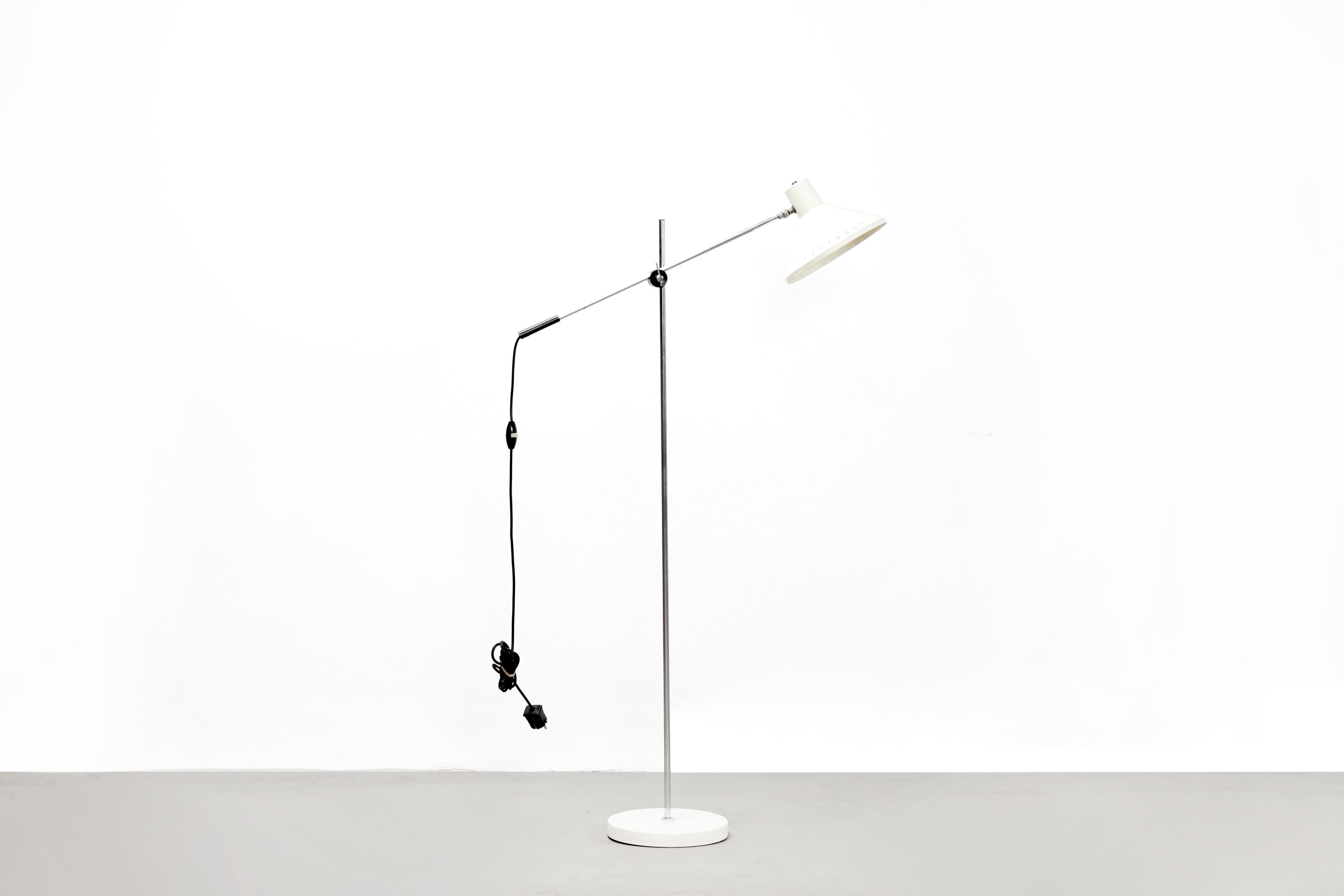 Standing floor lamp by Dutch manufacturer Anvia designed by J. J. M. Hoogervorst. This lamp is made from white lacquered metal which will fit well in any interior. The lamp is adjustable in height and forwards or backwards. The design and