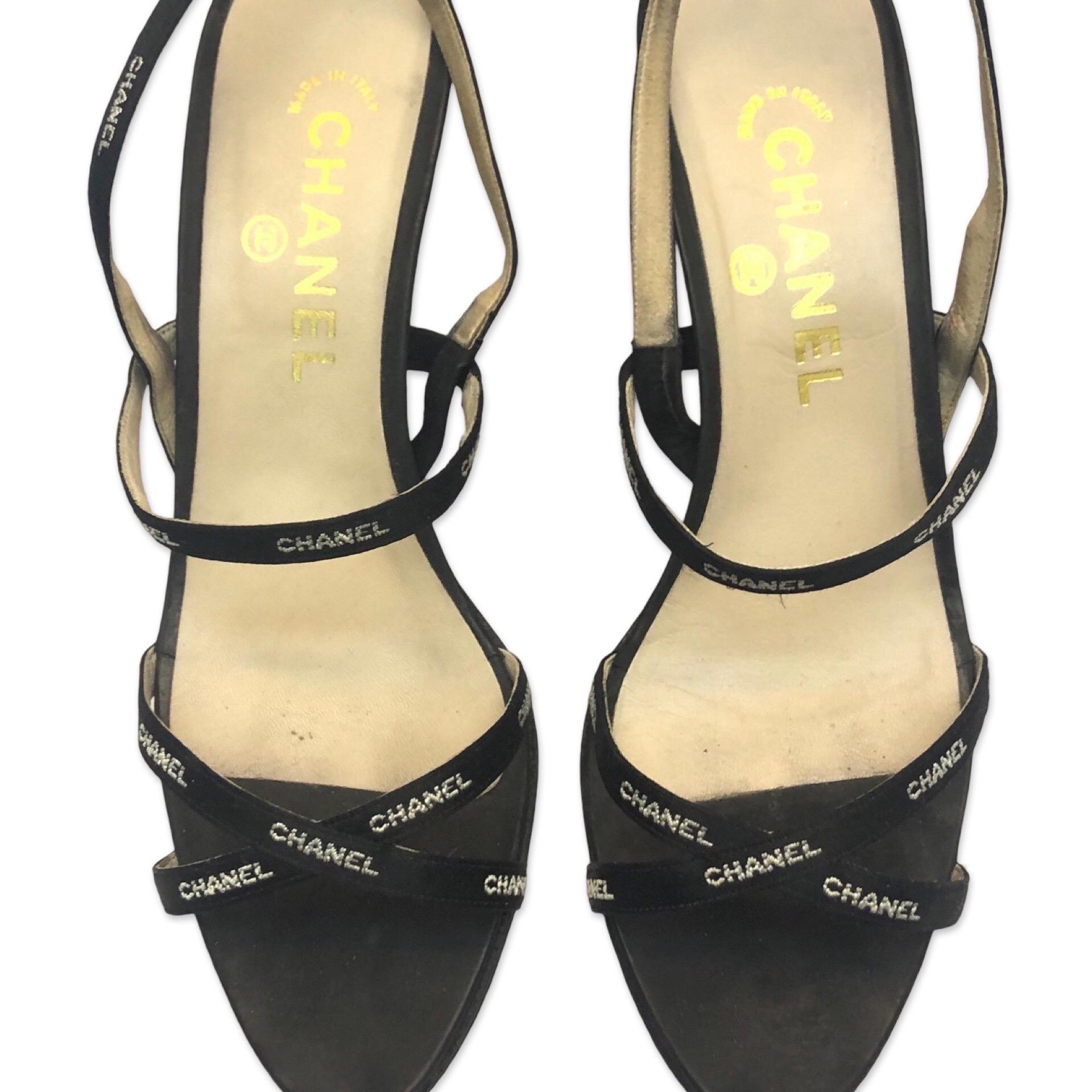 - White embroidered Chanel print on black silk straps sandals heels from the 90s. Karl Lagerfeld can always make Chanel products to be subtle and iconic, in his most possible way! 

- Size 37.5. Heels height 9cm.

