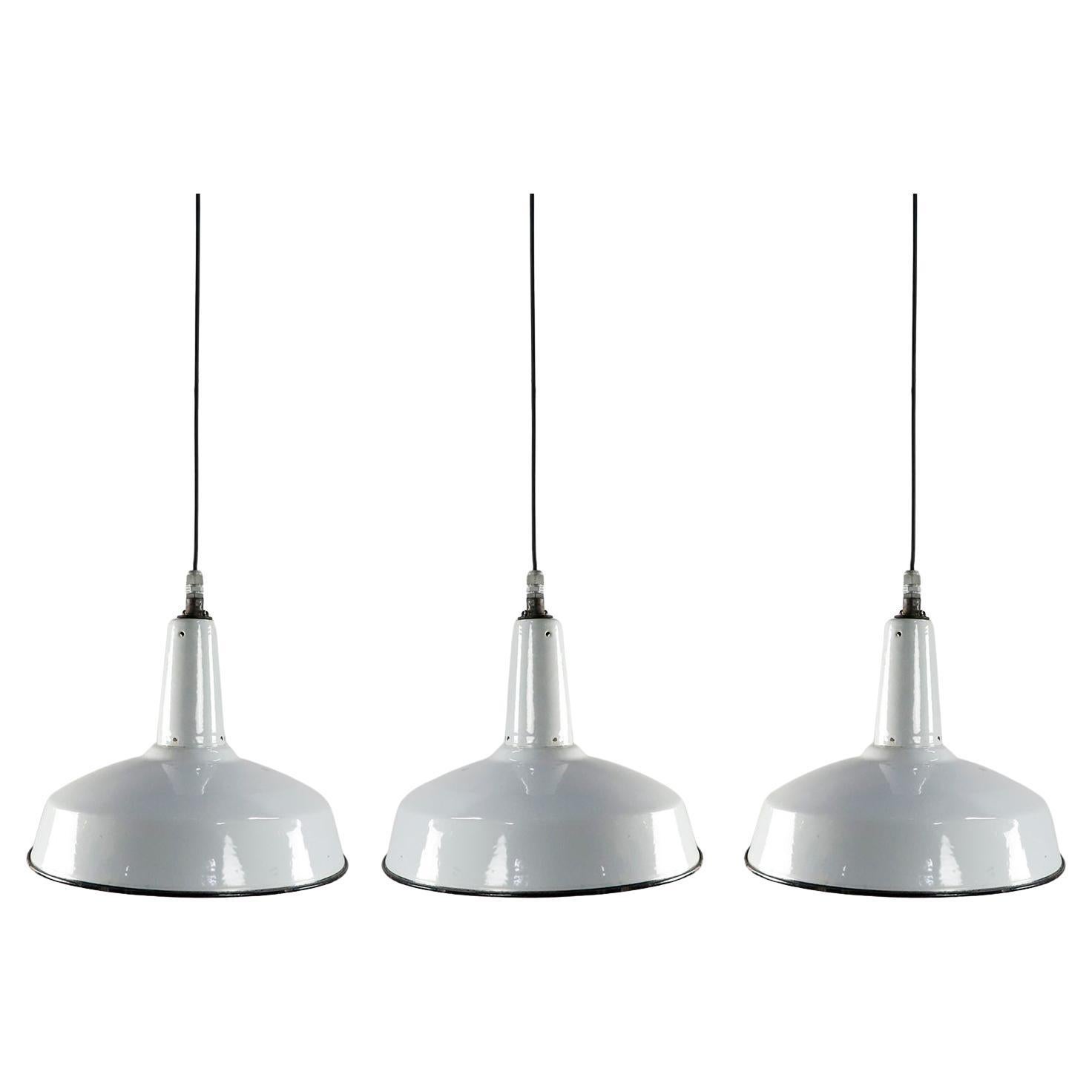 White Enamel and Cast Iron Industrial set of three Pendant Lights For Sale