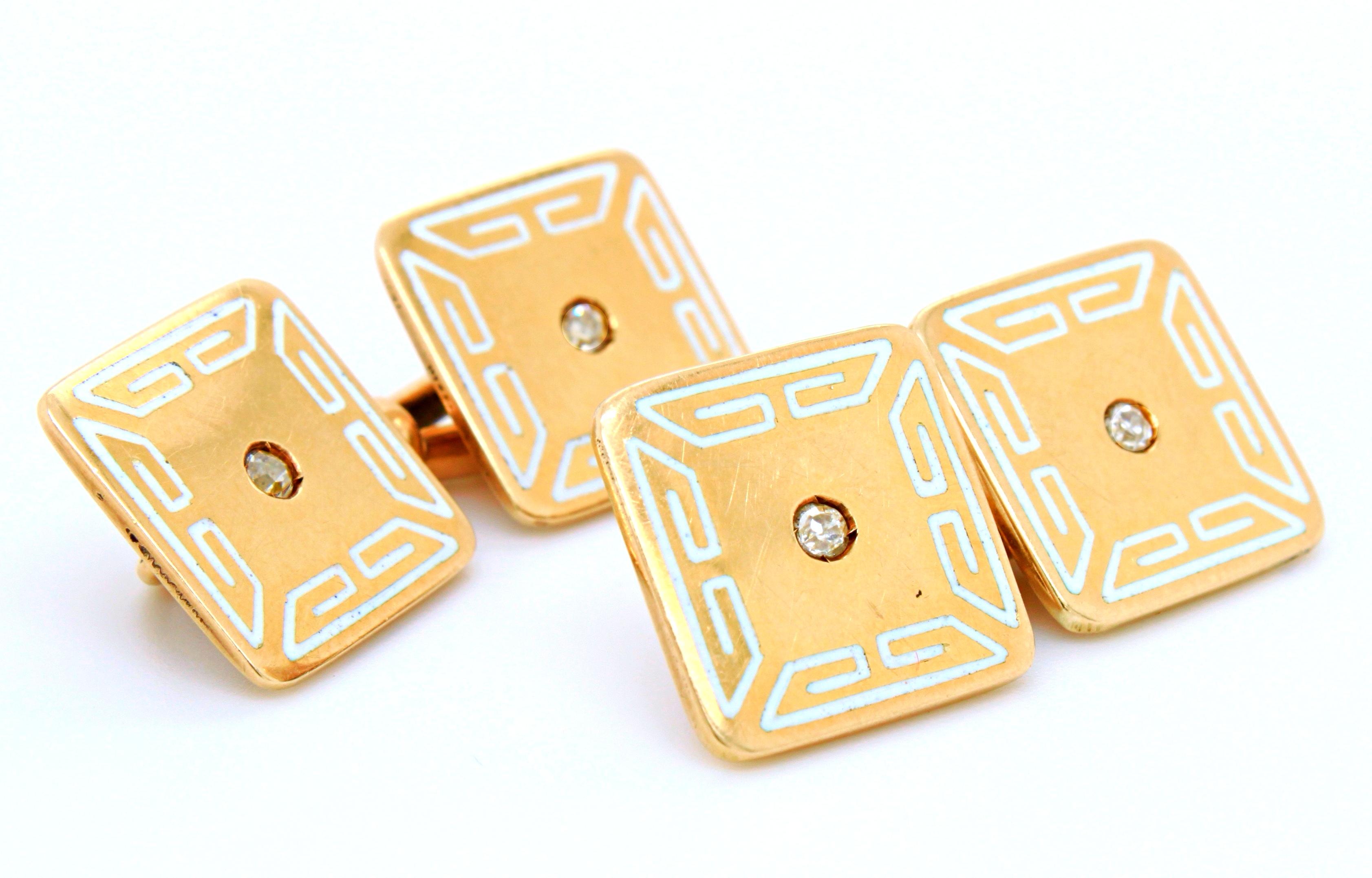 An Art Deco pair of white enamel, diamond and gold cufflinks, ca. 1920s. They are square shaped, each with an old cut diamond in the centre and a geometric white enamel border - inspired by Egyptian architecture.

The elegant combination and