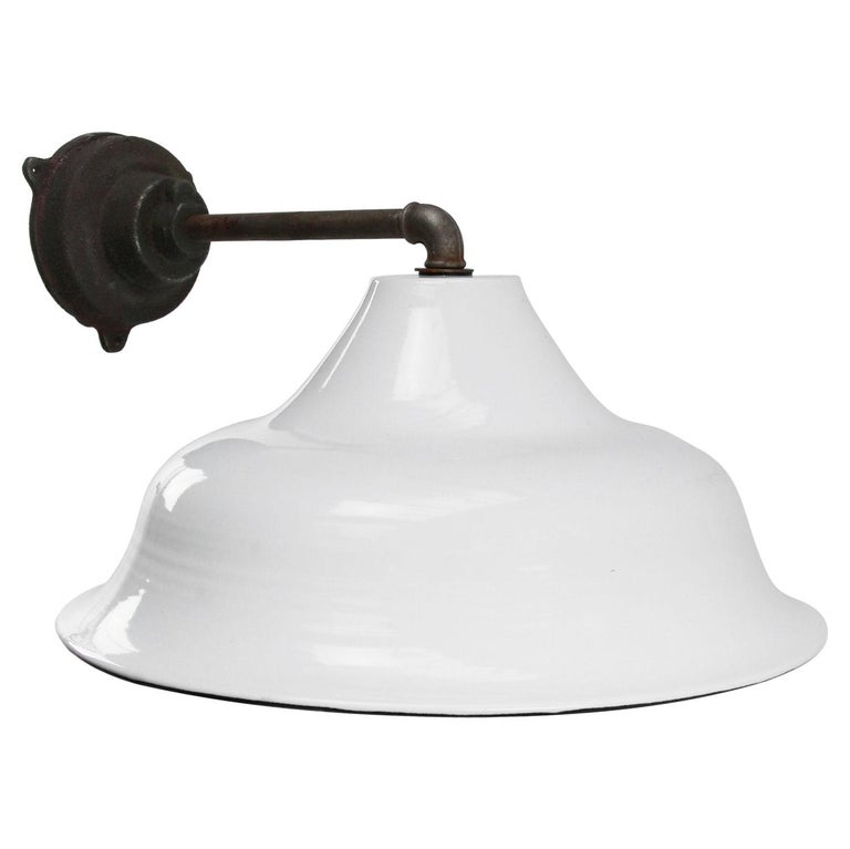 Factory wall light. White enamel. White interior. 

Diameter cast iron wall piece: 12 cm, three holes to secure.

Weight: 3.40 kg / 7.5 lb

Priced per individual item. All lamps have been made suitable by international standards for