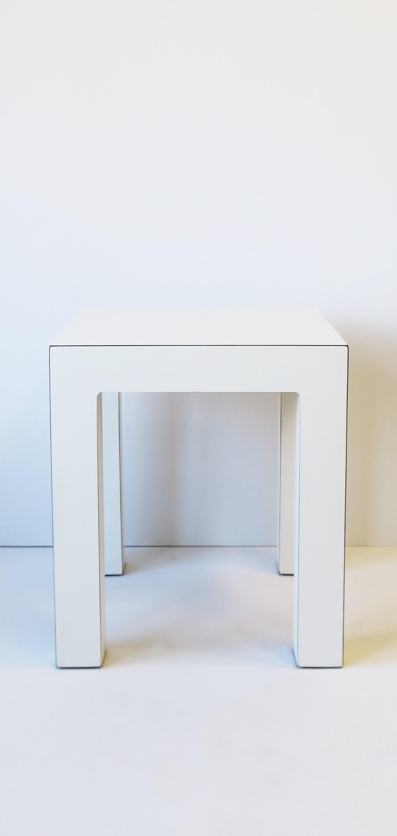 A '70s Modern white matte laminate end table with nice lines, circa 1970s late 20th century. Great as an end table or other uses, in a convenient size. Dimensions: 16