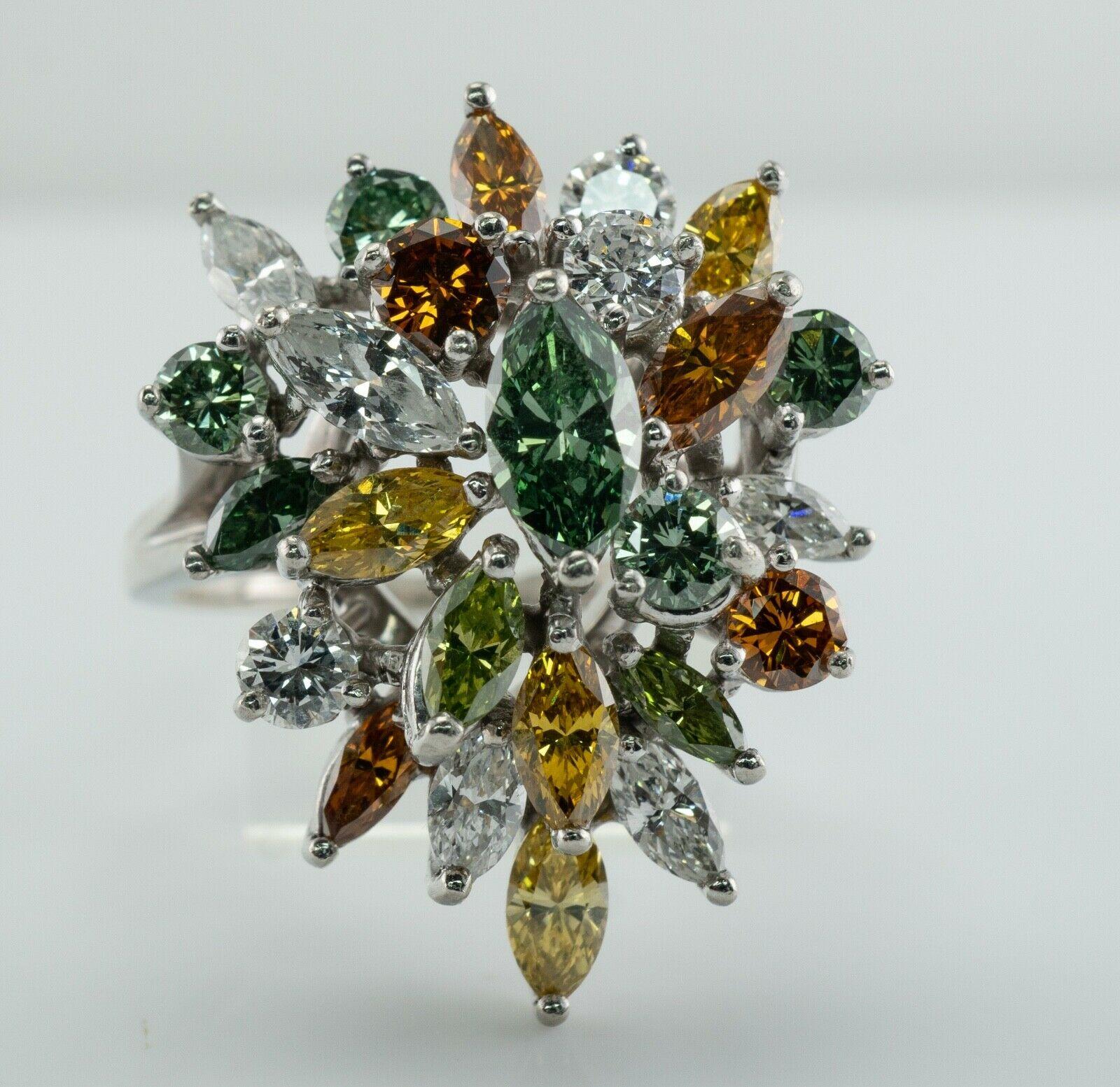 This gorgeous estate ring is crafted in Platinum and set with natural white and fancy diamonds.
The top is studded with 25 diamonds.
Three white round cut diamonds total .45 carat of SI1 clarity and H color.
Six green and orange round cut diamonds