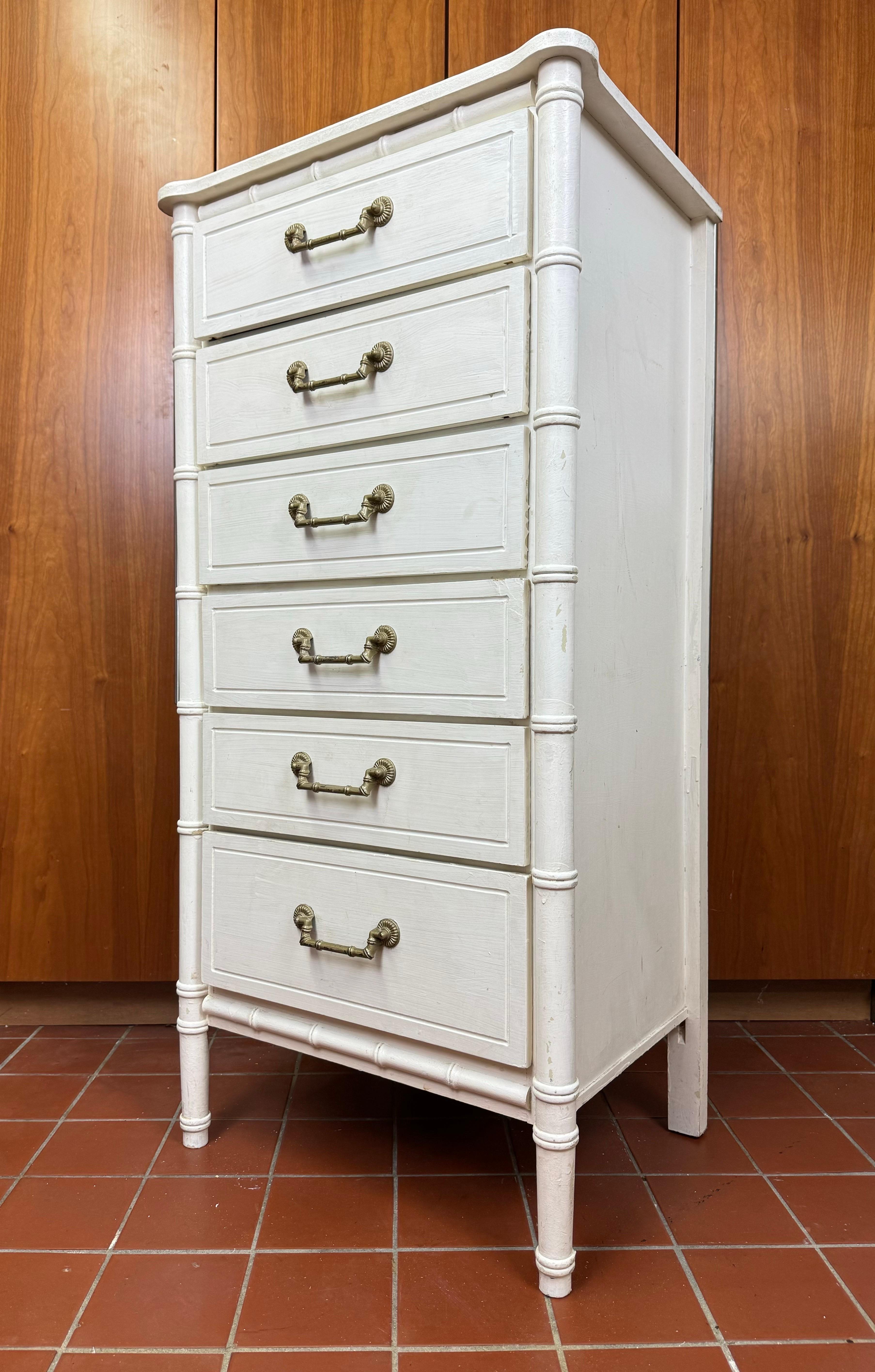 White Faux Bamboo Six Drawer Dresser. Tall and upright this dresser is perfect for saving space in a room. Ideal for lingerie or for a child's room. Classic palm beach style. Could use a fresh coat of paint.