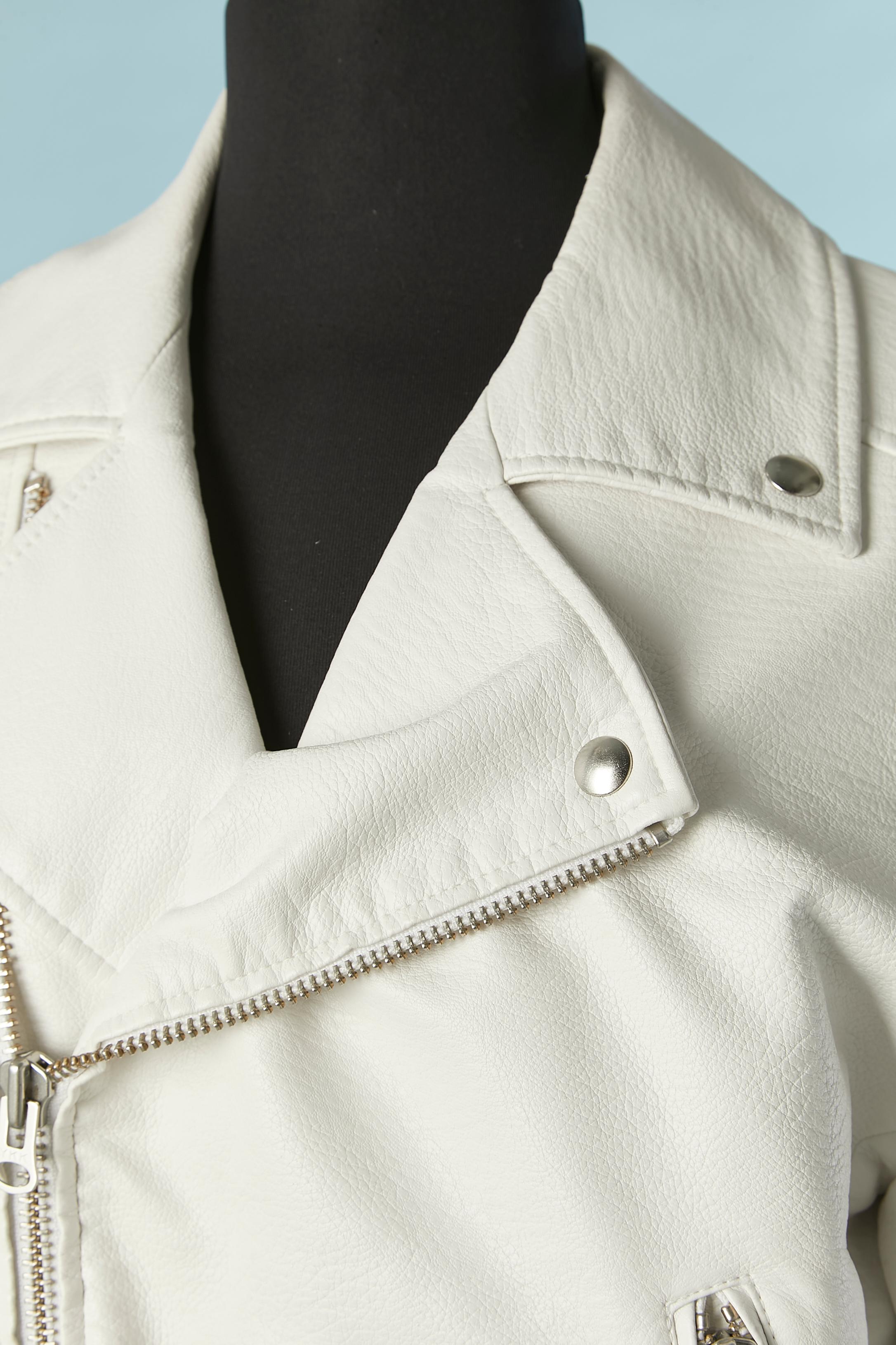 White faux leather biker jacket. Shell composition: 100% polyurethane. Lining: 100% polyester. 
Zip closure middle front + on side pocket. One small pocket with snap closure. Zip on cuffs as well. 
SIZE XS on tag but fit S and M 
