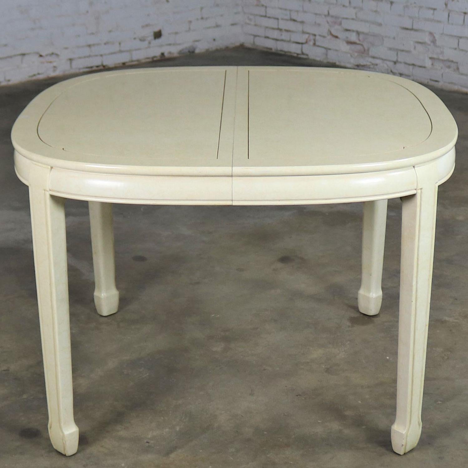 Handsome off-white Asian style, Ming style, or Chinoiserie oval dining table with two leaves by White Fine Furniture. It is in wonderful vintage condition. There are a few nicks and dings as you would expect for its age but nothing outstanding. We