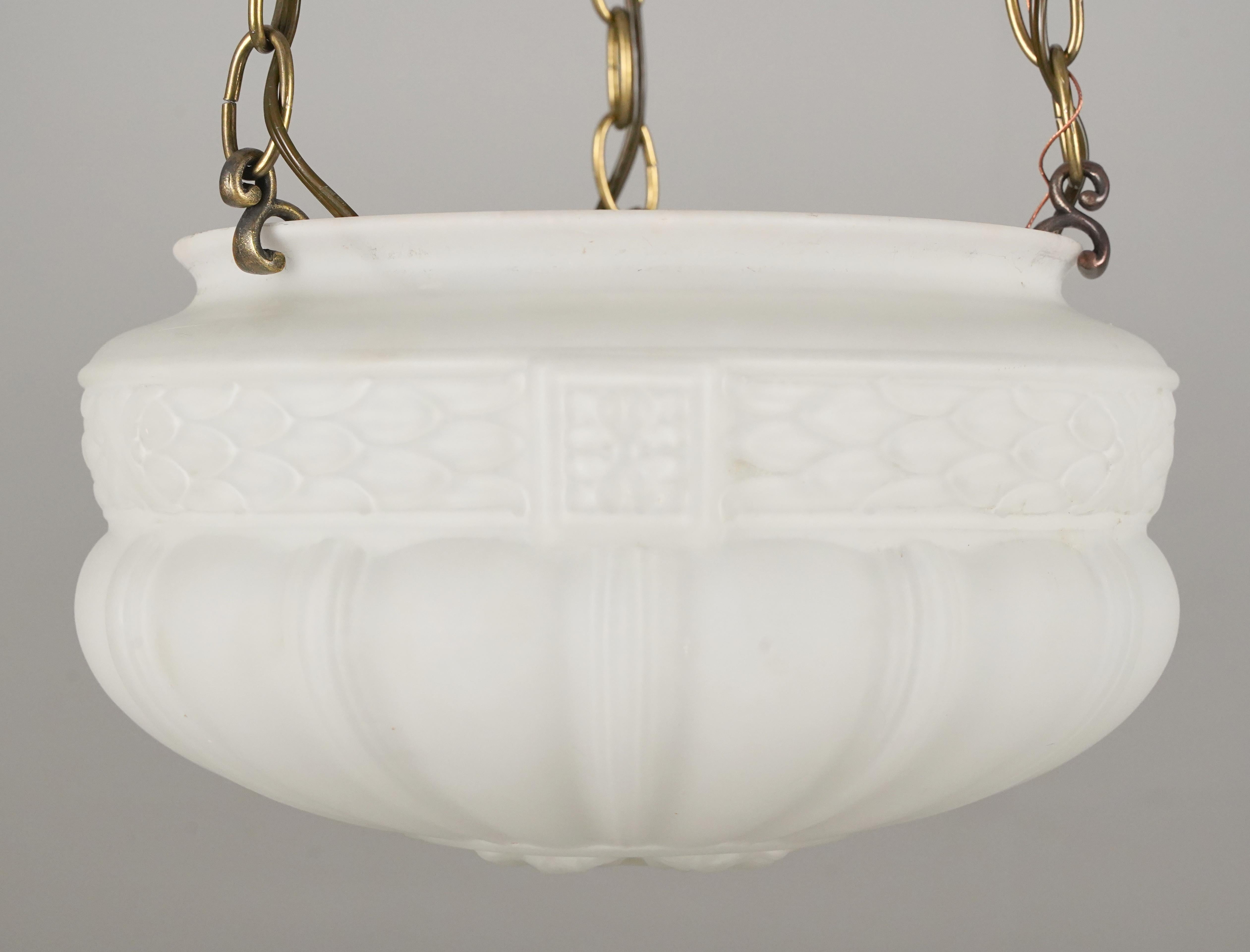 Pendant light made of a white ornate fluted bowl glass shade, brass finished canopy, and steel chain. This requires three standard Edison style medium base bulbs. This light is cleaned and restored. Please note, this item is located in our Scranton,