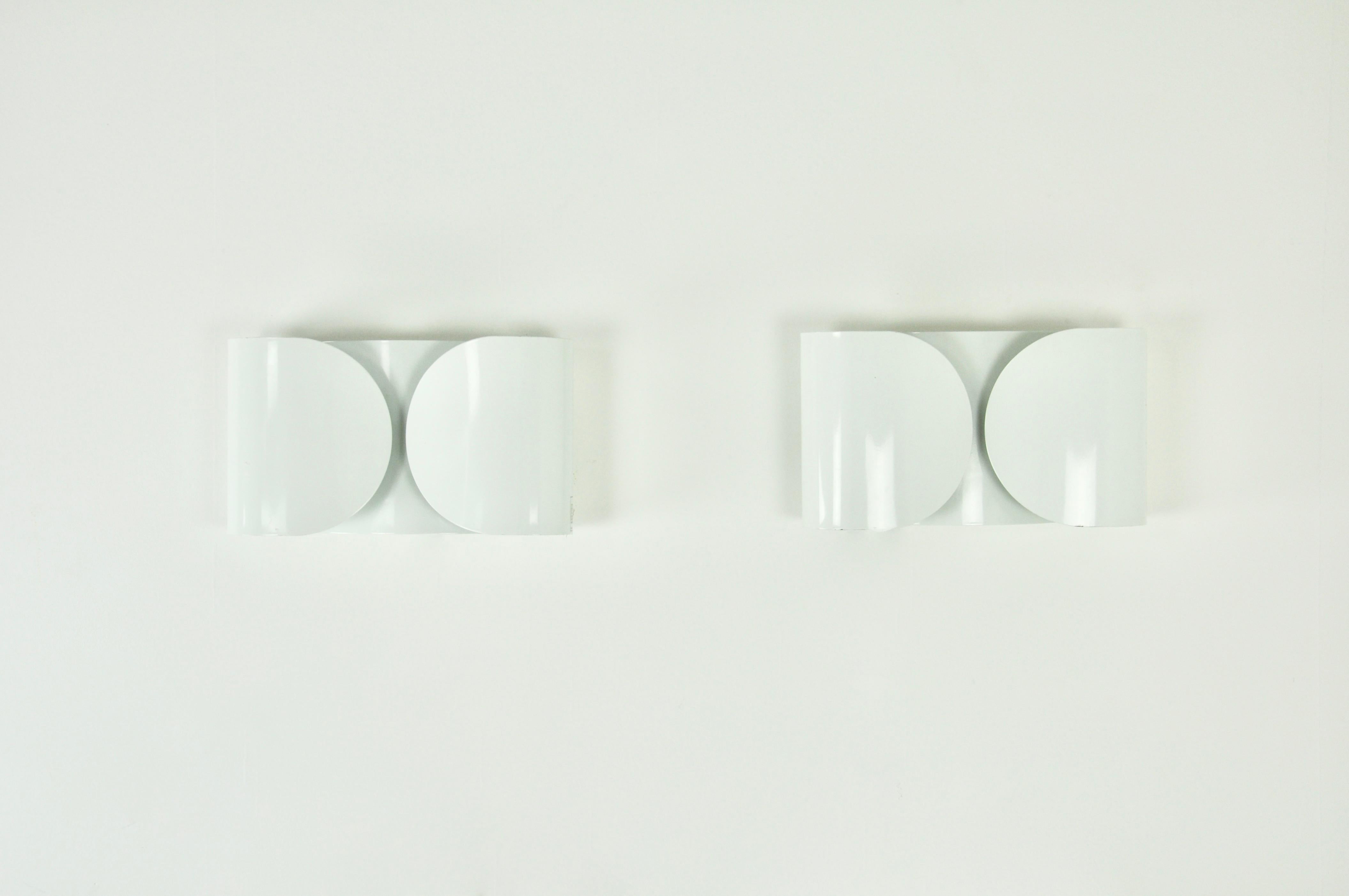 Pair of sconces in white color metal. stamped Flos. Wear due to time and age of the sconces.