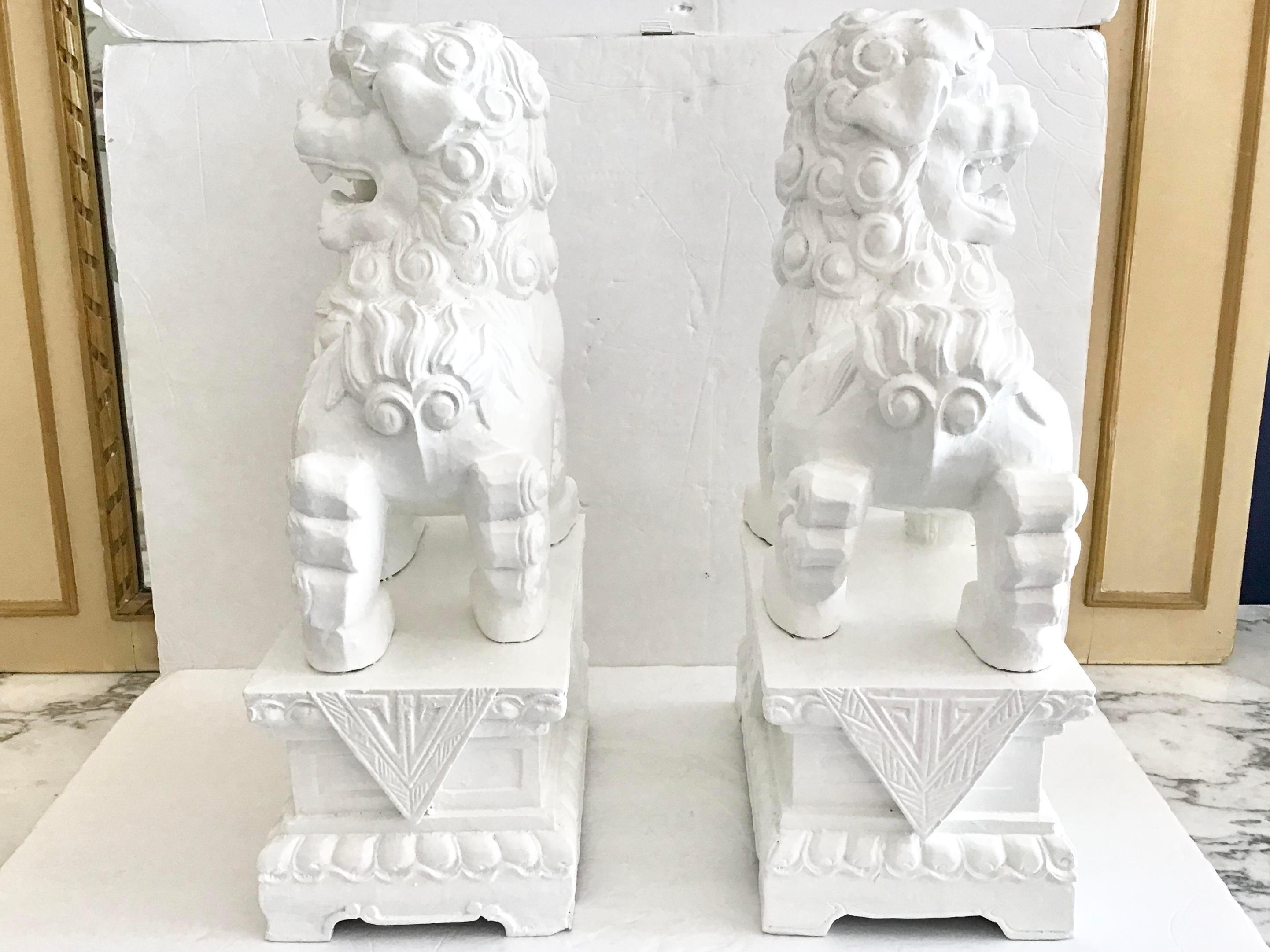 Chinoiserie White Foo Dogs Carved in Wood Base Geometrical Figures, a Pair For Sale