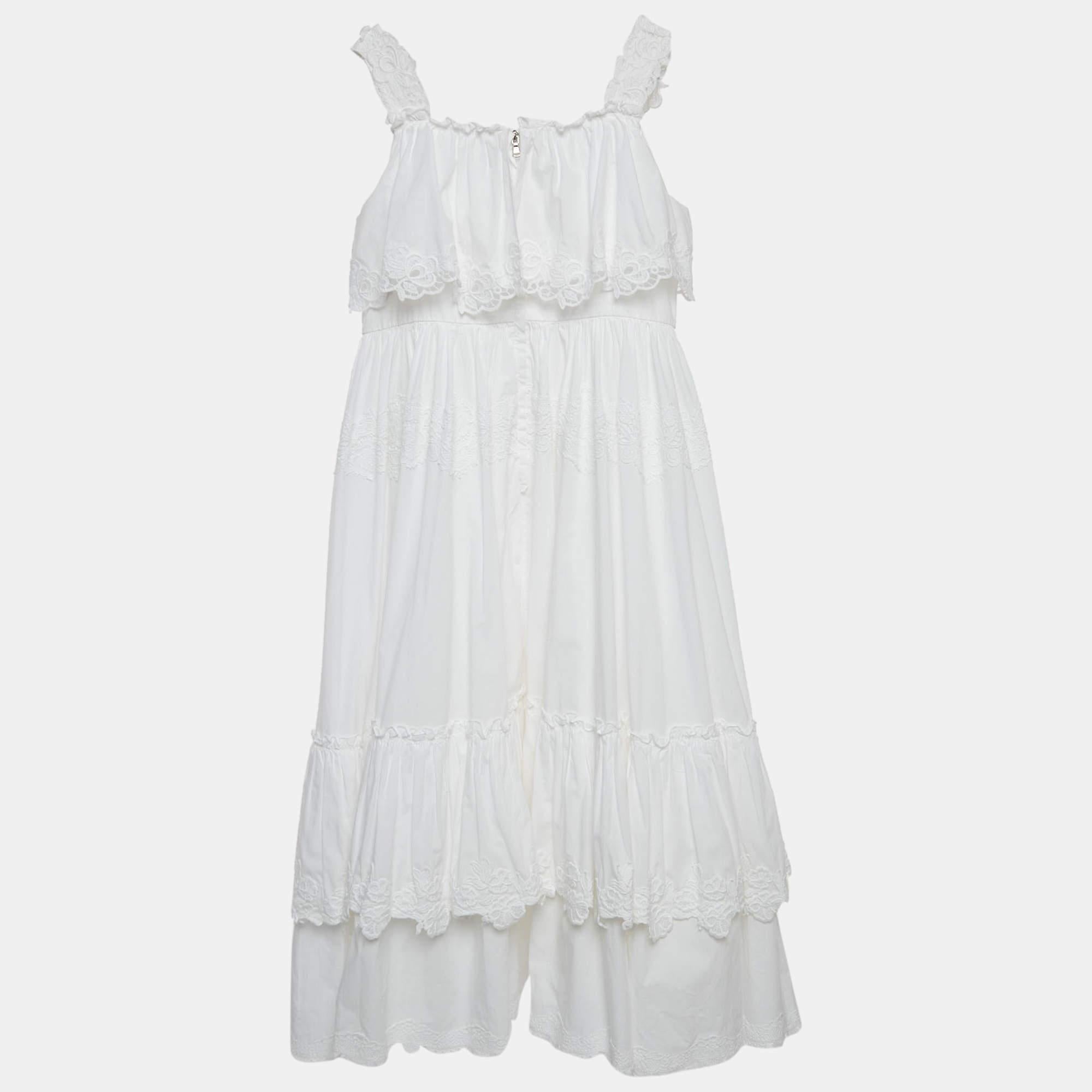 The Dolce & Gabbana dress epitomizes timeless elegance. Crafted from pristine cotton, the dress features delicate lace trimmings that add a touch of romantic sophistication. With a flattering silhouette and meticulous detailing, it seamlessly blends