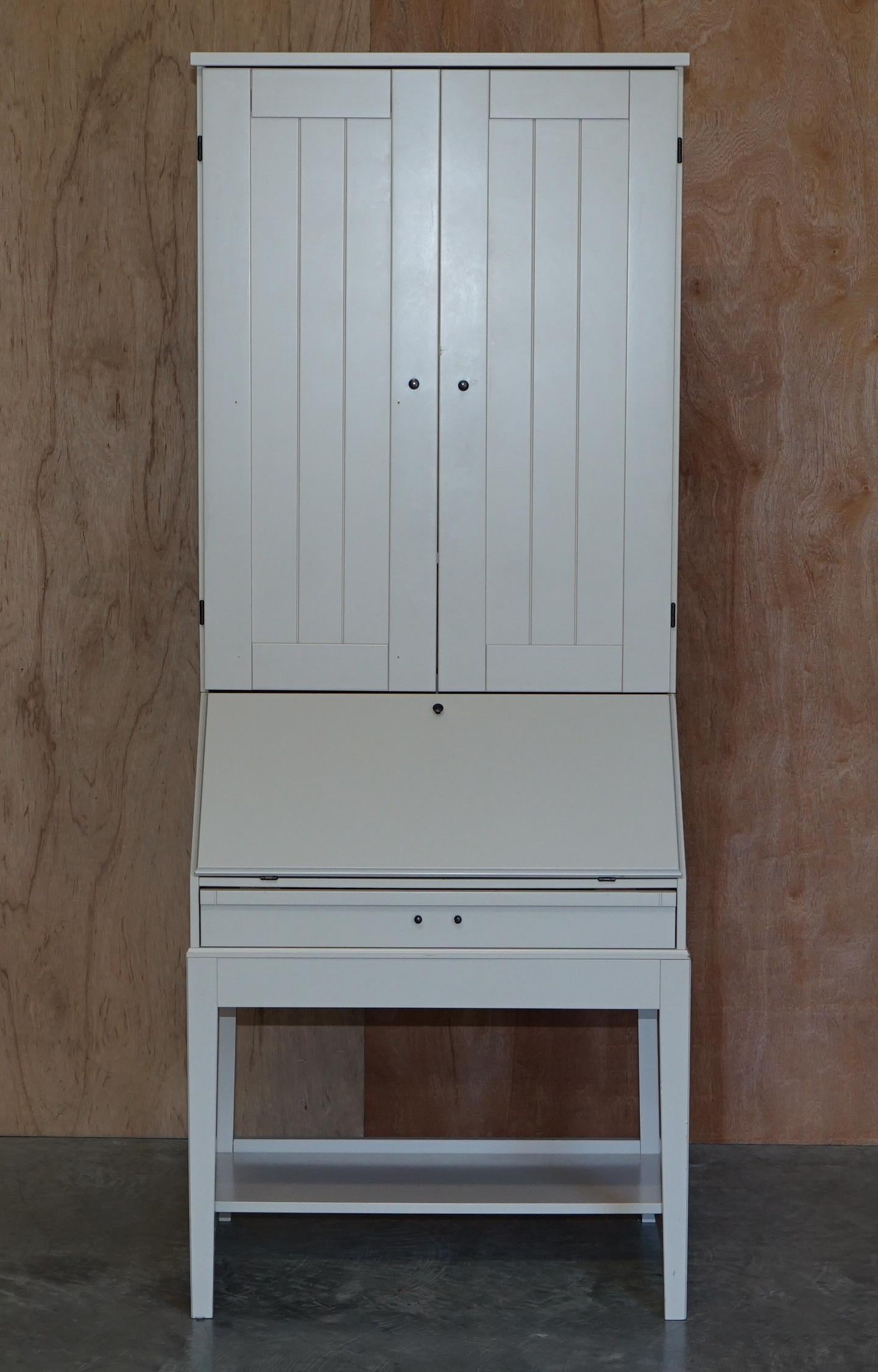 We are delighted to offer this nice utilitarian free standing white bookcase with writing bureau base. 

My wife purchased this a few years ago for our daughters bedroom, she used the top section for storing books and the base as a work station.