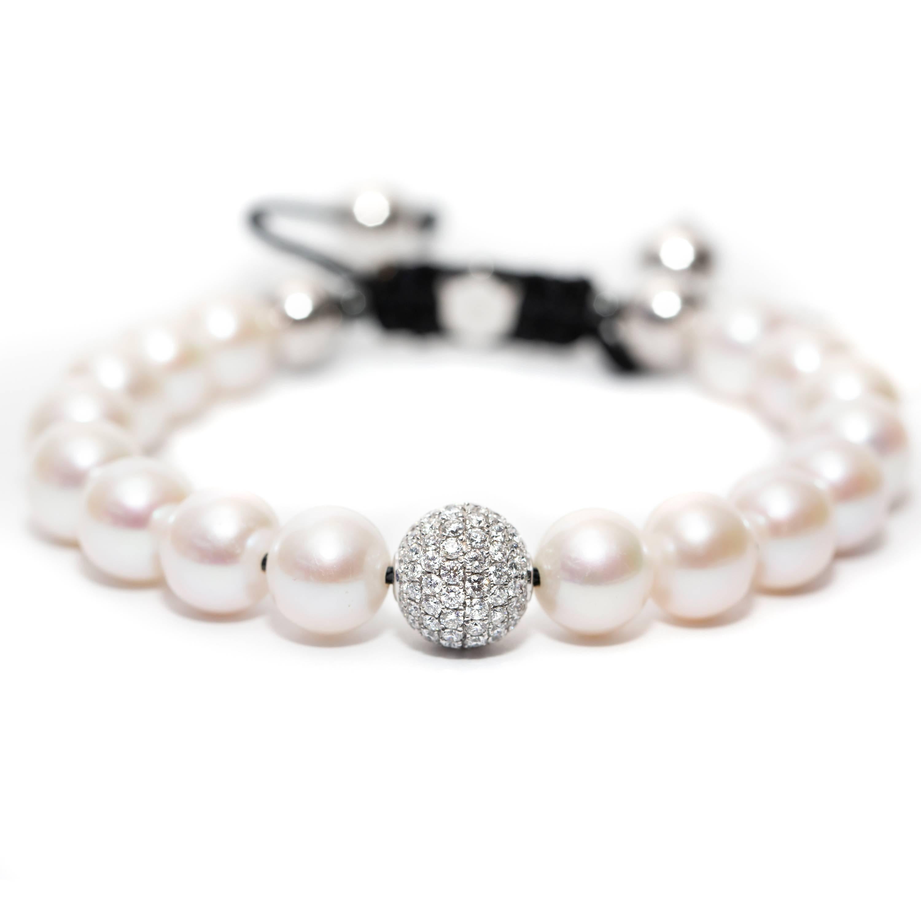 This Contemporary fresh water Pearl Bracelet features an adjustable Cord further highlighted with a Pave set 1.80 Carat Round Brilliant Color G Clarity VS Diamond sphere set in 18 Karat White Gold for a luxurious feel. Available in a choice of