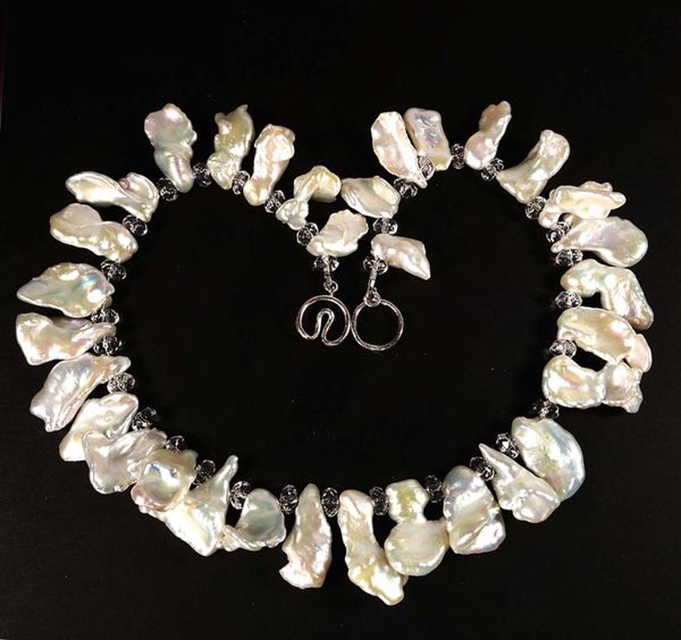 Necklace of White Iridescent free form Pearls and faceted clear Quartz crystal rondelles.  The Pearls are gently graduated from 17 x 9 mm to 23 x 12 mm.  This 14.5 inch choker necklace is secured with a Sterling Silver clasp.  More from this jeweler