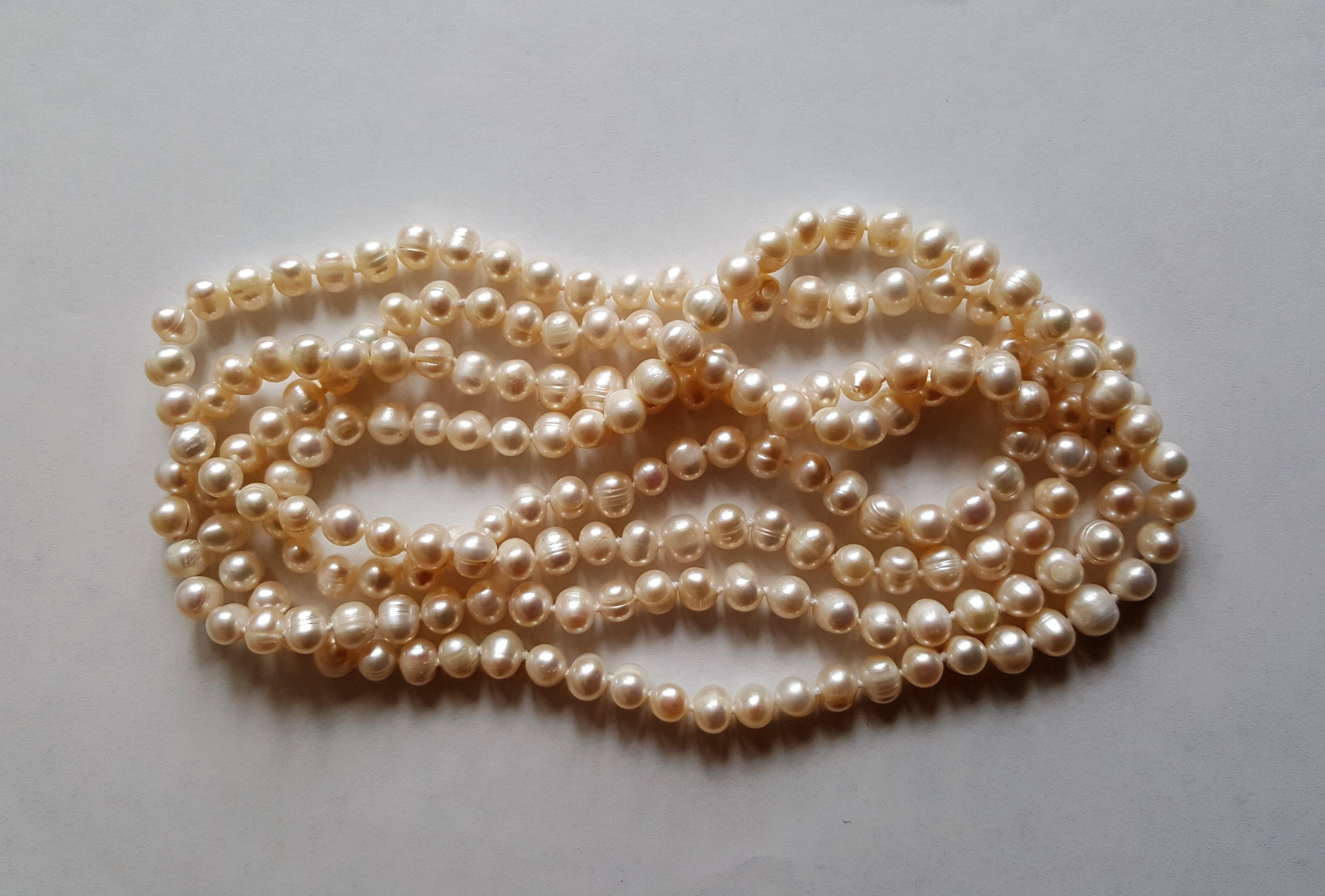 A beautiful strand of white freshwater pearls that is 56 inches in length. Pearls are in very good condition and range in size from 6mm to 8mm and have a lustrous nacre. These pearls make a beautiful double strand and are classic and timeless