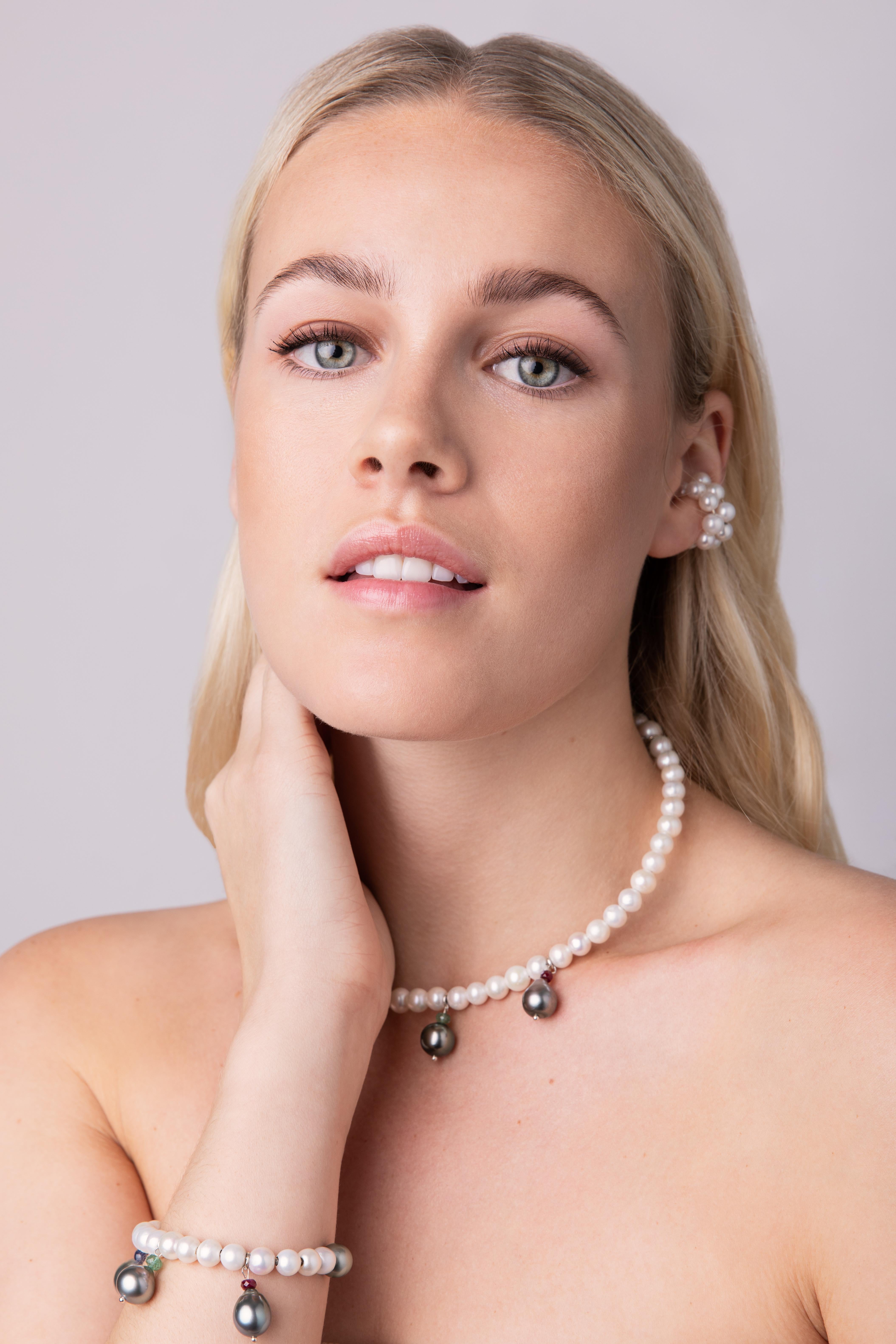 This choker is contemporary and super stylish. Its shape is inspired by a classic piercing. 
The Tahiti pearls have a baroque drop shape, each crowned by a different gemstone and move with each step, drawing attention to the most beautiful part of