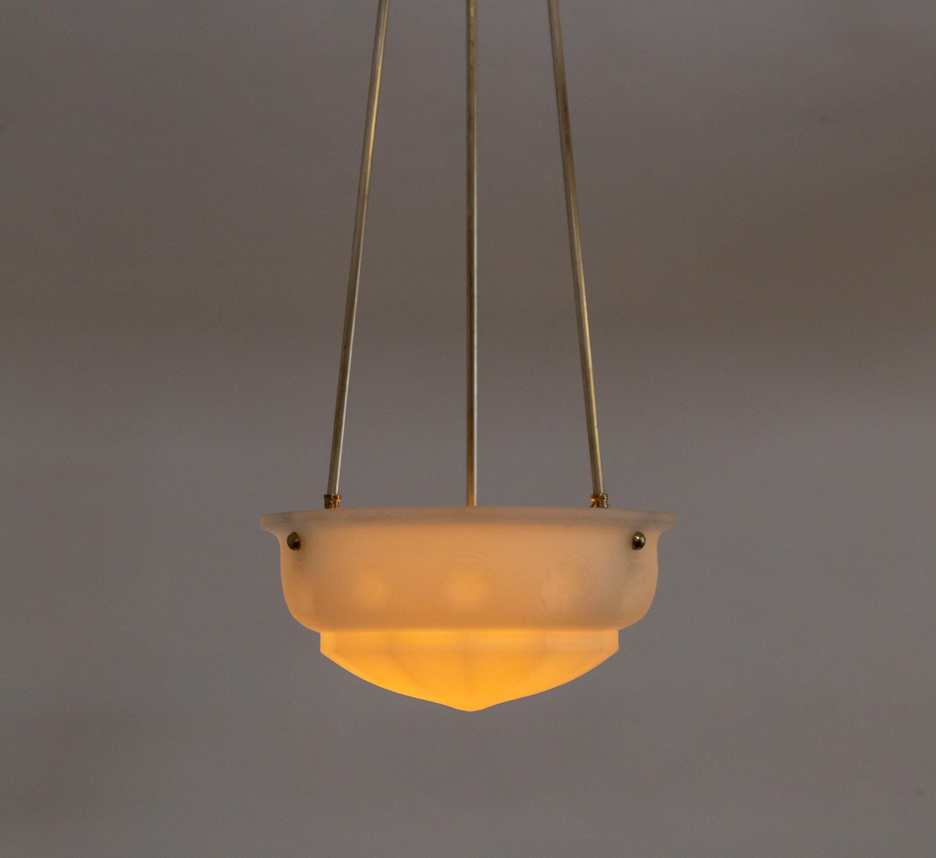 A three-stem pendant light with a frosted glass shade from the early 1900s.  The glass is a lovely molded bowl shape with subtle rosette details.  The long, elegant stems holding the shade are pewter-tinted brass; with a matching canopy.  Newly