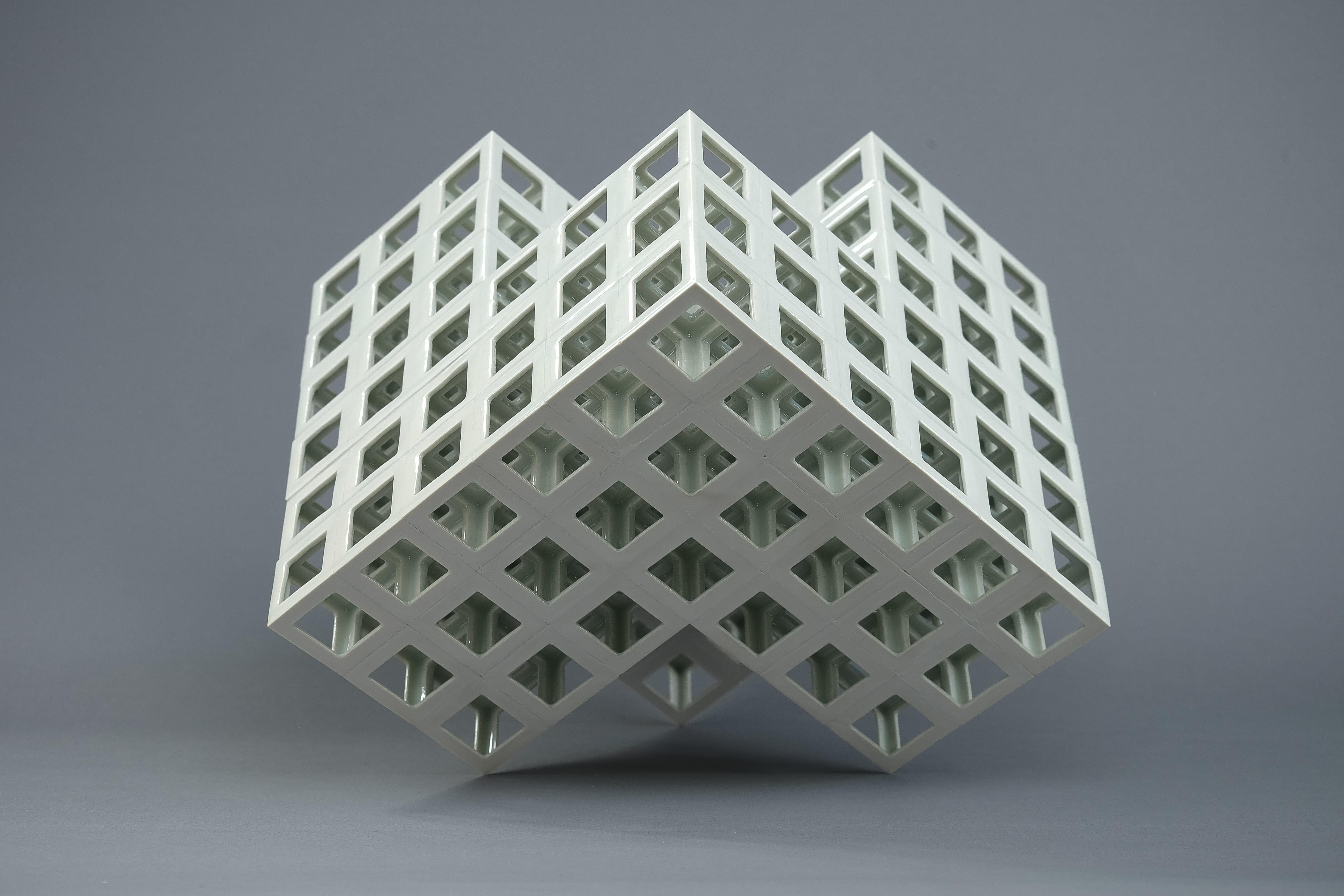 “Lattice receptacle” series is a work of art made out of porcelain lattice structure as a fundamental form. Its creation is constructed by the accumulation of the base unit (cubic hollow) that is formed regularly by slip casting technique. For his