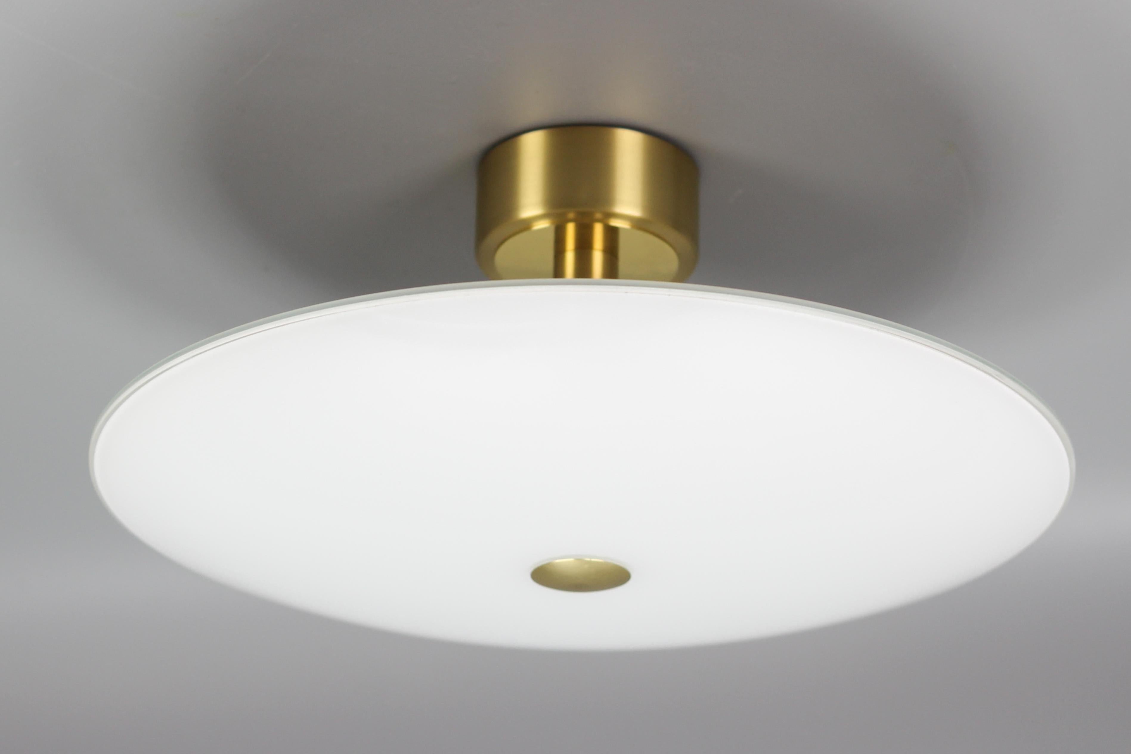 B + M Leuchten brass and white glass flush mount, Germany, circa 2015.
An elegant and beautifully shaped white glass and brass flush mount, made in Germany, with one socket for the B15d size light bulb.
Dimensions: height: 22 cm / 8.66 in; diameter: