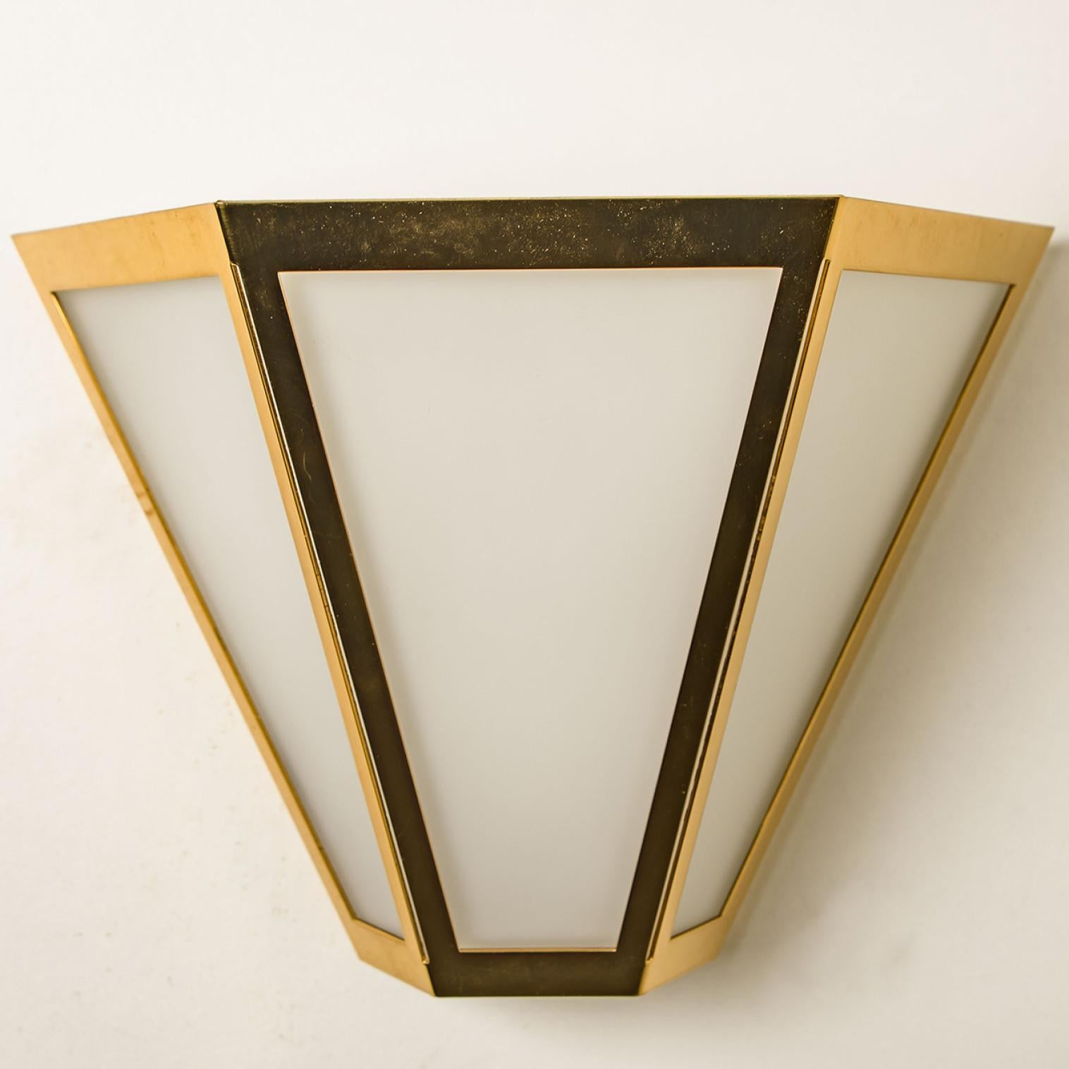 Pyramid shaped wall lights in white opaline glass with brass details. Manufactured by Glashütte Limburg in Germany during the 1970s. (early 1970s). Nice craftsmanship. Minimal, geometric and simply shaped design.

Please note the price is for 1