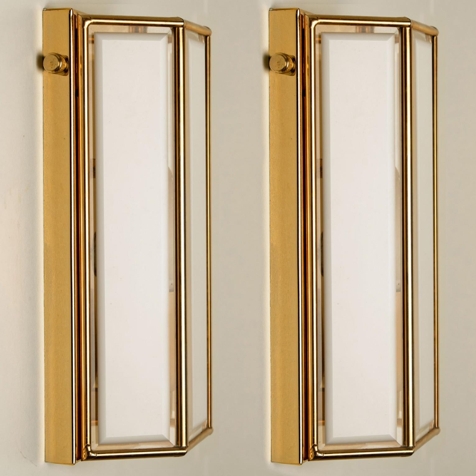 Triangle shaped wall lights in white opaline glass with brass details. Manufactured by Glashütte Limburg in Germany during the 1970s. (early 1970s).
Nice craftsmanship. Minimal, geometric and simply shaped design.

Cleaned, well wired and ready to