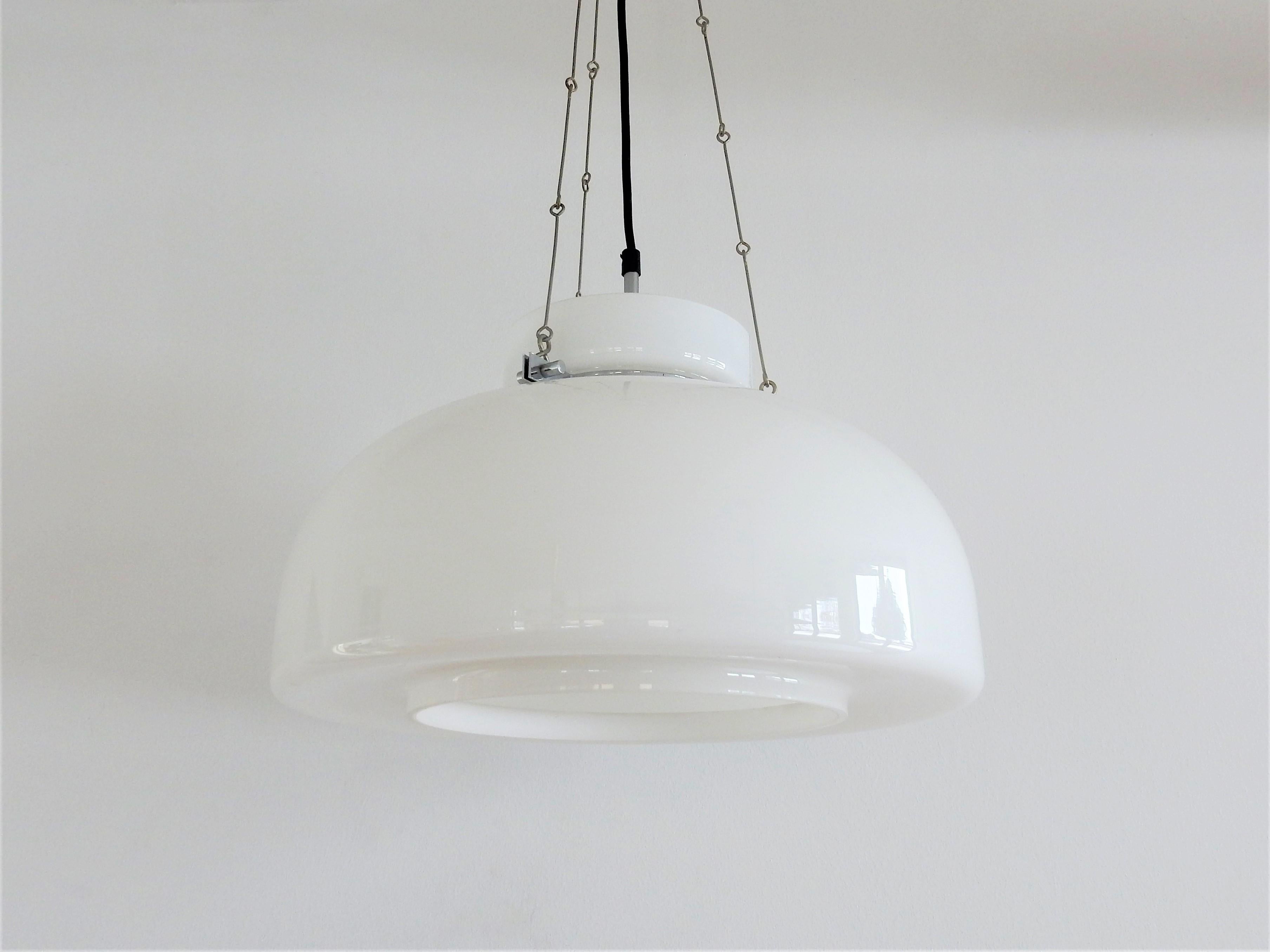 This quite rare pendant lamp was designed by Herbert Proft for Glashütte Limburg in Germany in the 1970s. It has a white and opaline glass shade, a chromed ring with 3 connecting screws, hanging on three chains. The white glass gives a nice and soft