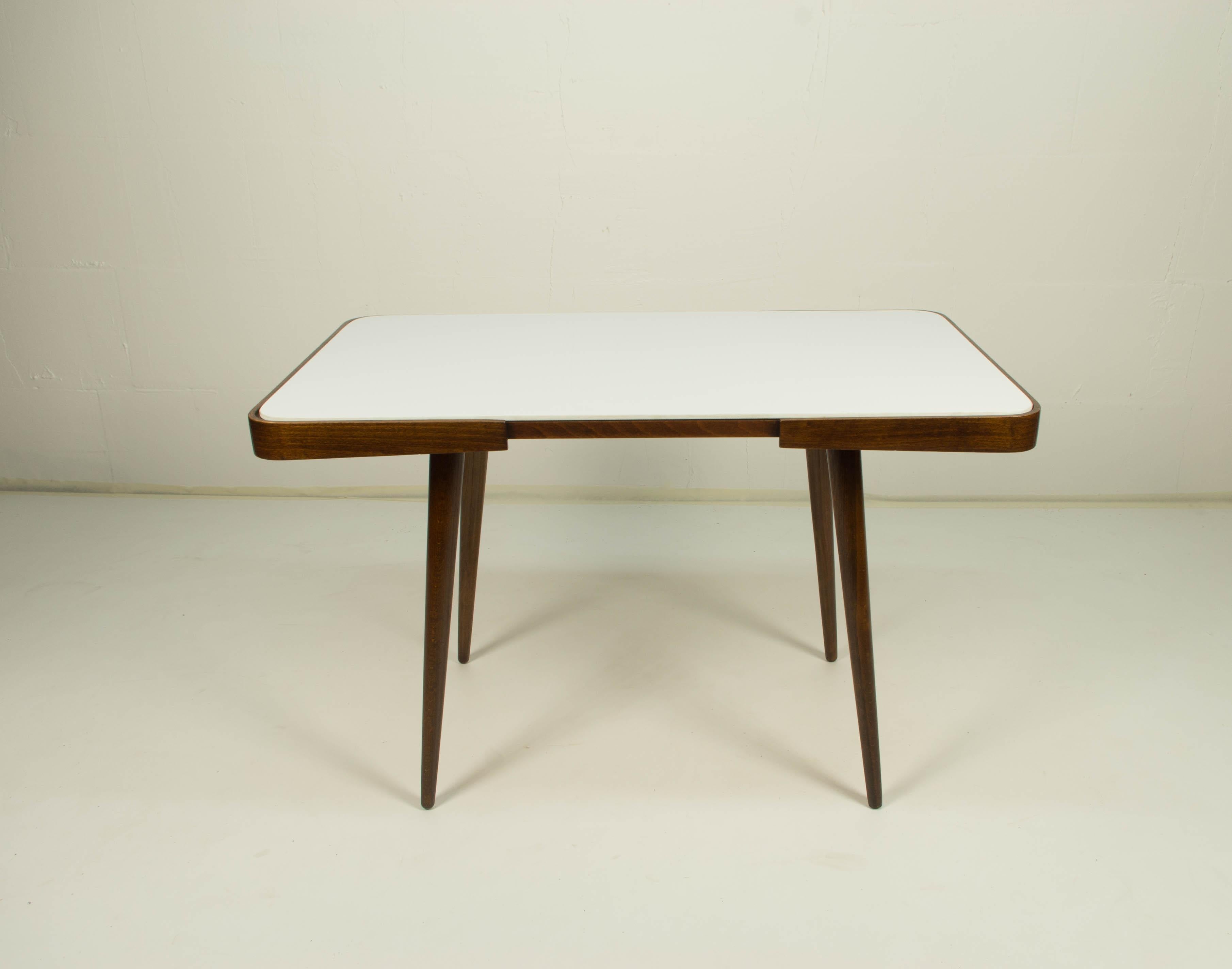 Coffee table with white glass top, mid-1960s. Designed by Jiri Jiroutek for Interier Praha. Original very good condition, wood polished.