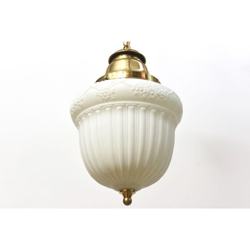 White glass pendant with floral design. Single Bulb Brass fixture. American, C. 1915. Completely restored and rewired, ready to hang.

Dimensions: 
Height: 22