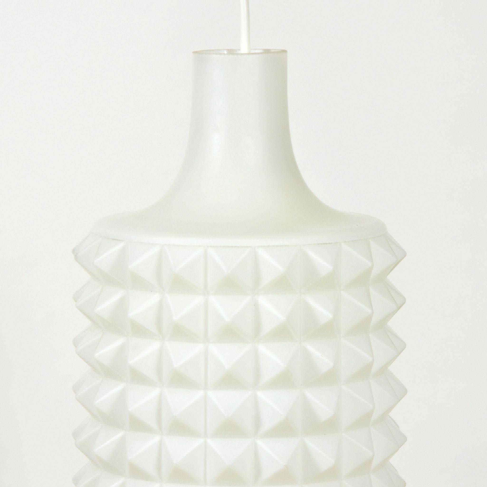 Vintage pendant with glass lamp-shade in white color, with plastic motive of spikes. Without any damages. New length adjustable wiring. Equipped with one E27 screw bulb. Czechoslovakia, 1960s.