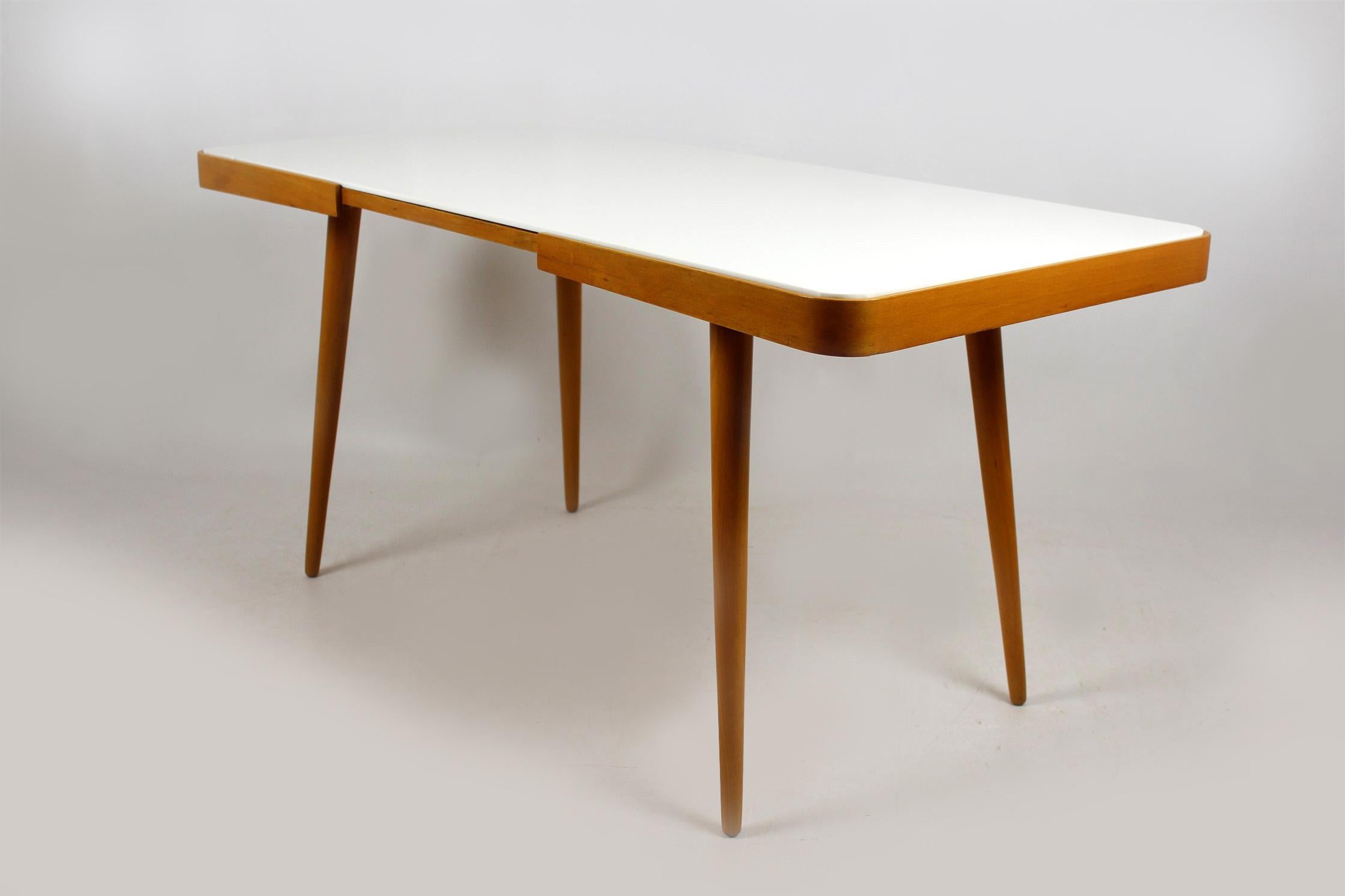 Coffee table with white glass top, mid-1960s. Designed by Jiri Jiroutek for interier Praha.
 