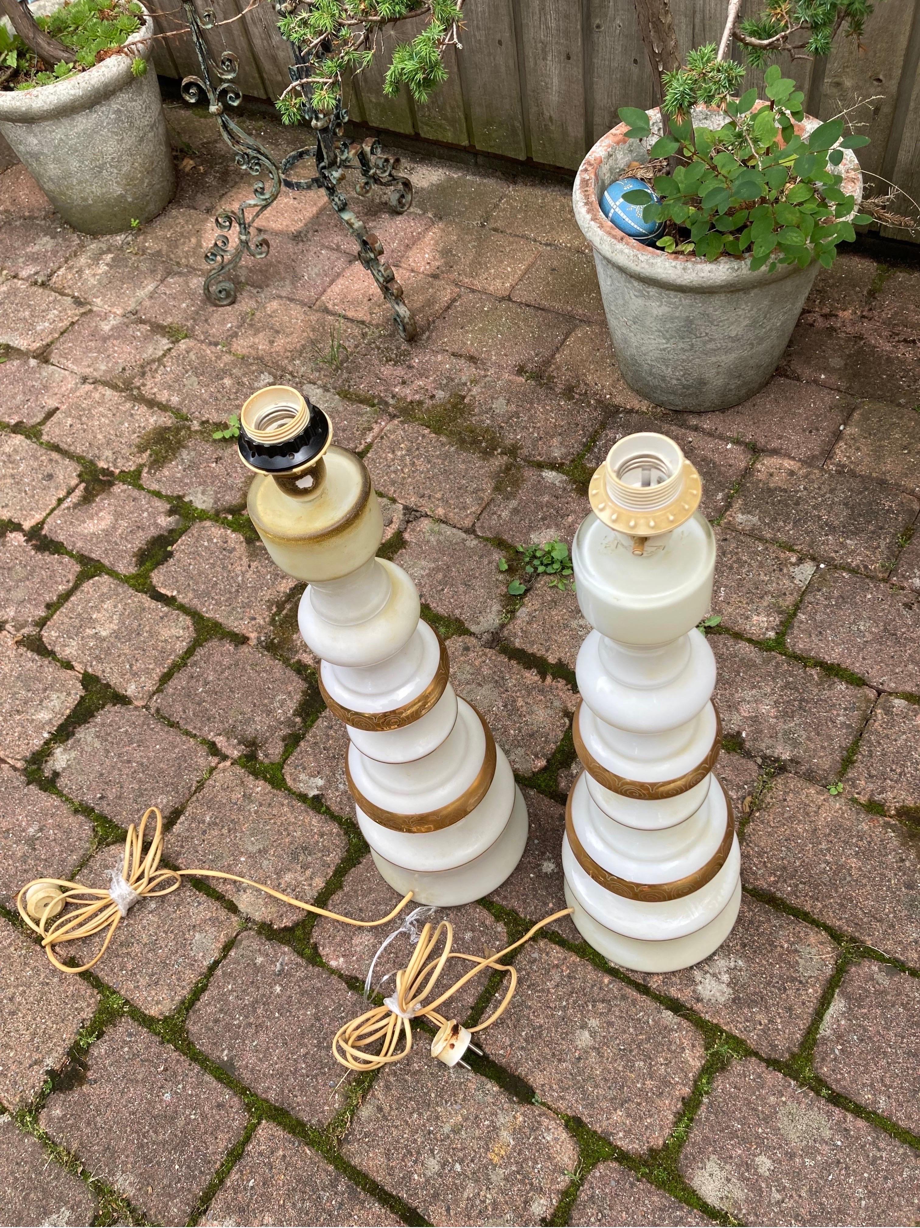 Pair of white glass with gold pattern mercury glass Rosdala lamps, 1970, Sweden
Organically shaped tall standing white glass that has gold inscription to it on a white glass body.
Rewired for the US.

 