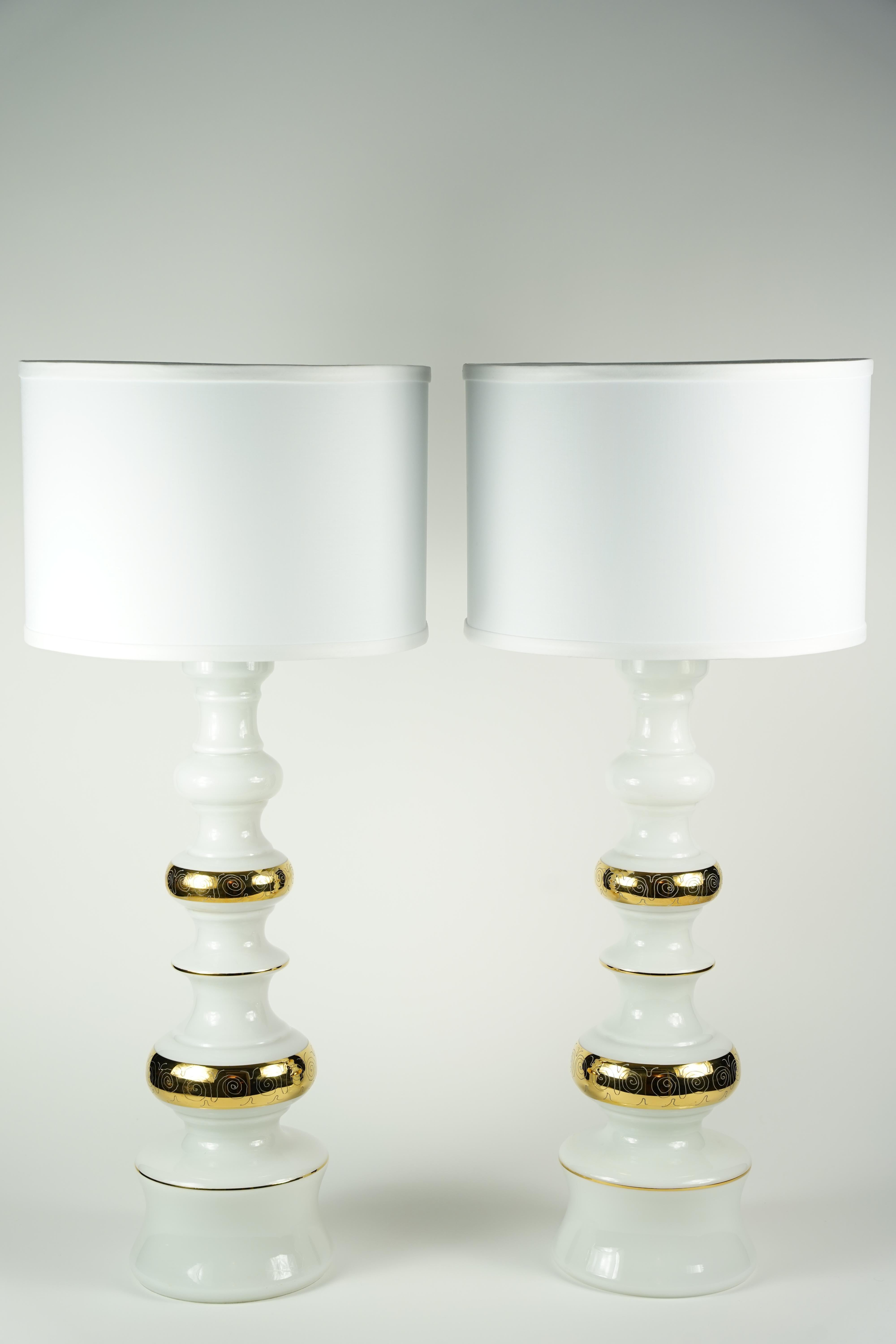 Pair of white glass lamps with gold pattern, Rosdala lamps, 1970 Sweden
Organically shaped tall standing white glass that has gold inscription to it on a large white glass body.
Rewired for the US.
New sockets and wires.

 